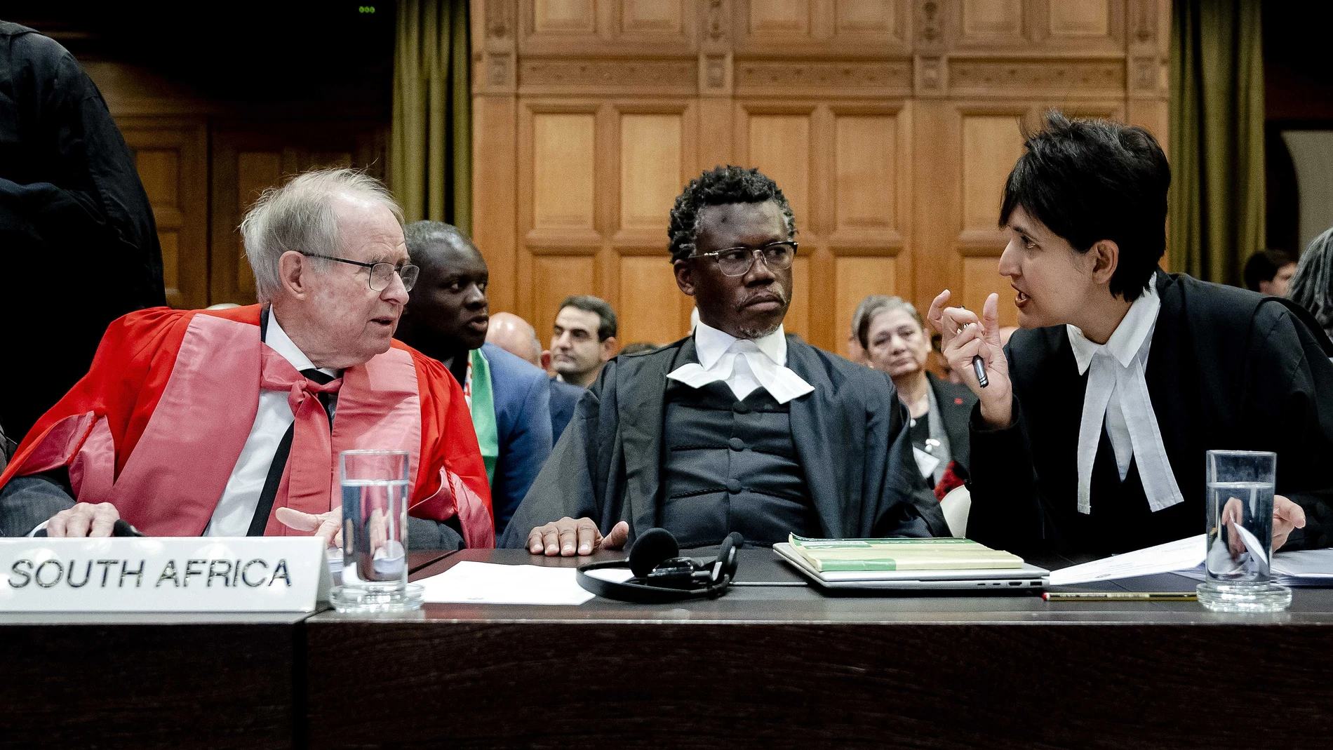 Hague (Netherlands), 12/01/2024.- (L-R) John Dugard, professor of International Law, lawyer Tembeka Ngcukaitobi and lawyer Adila Hassim, sit ahead of the hearing of the genocide case against Israel brought by South Africa, at the International Court of Justice (ICJ) in The Hague, The Netherlands, 12 January 2024. According to the South Africans, Israel is currently committing genocidal acts against Palestinians in the Gaza Strip, the allegations which has been denied by Israel. Thousands of I...