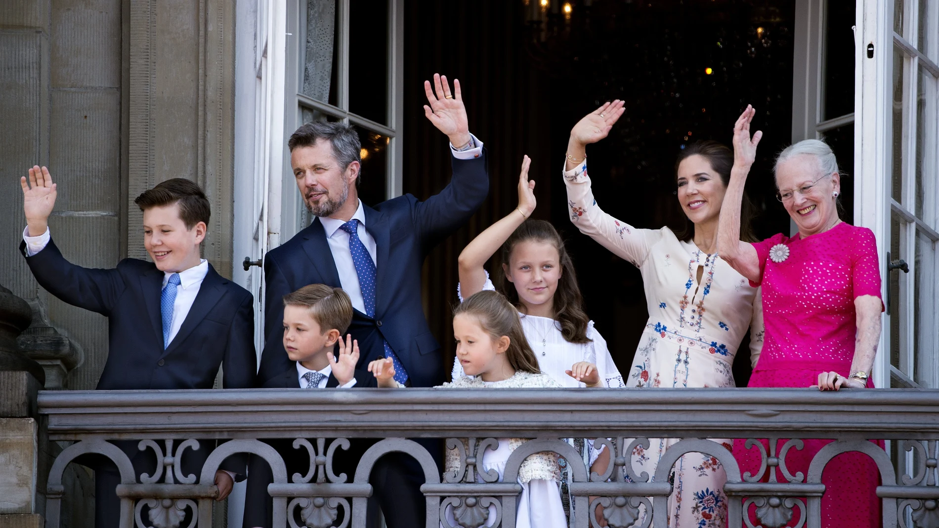 Denmark's Crown Prince Frederik (2-L), Crown Princess Mary (2-R), their children and Queen Margrethe II (R) wave on the balcony of Amalienborg Castle on the Crown Prince's 50th birthday, in Copenhagen, Denmark