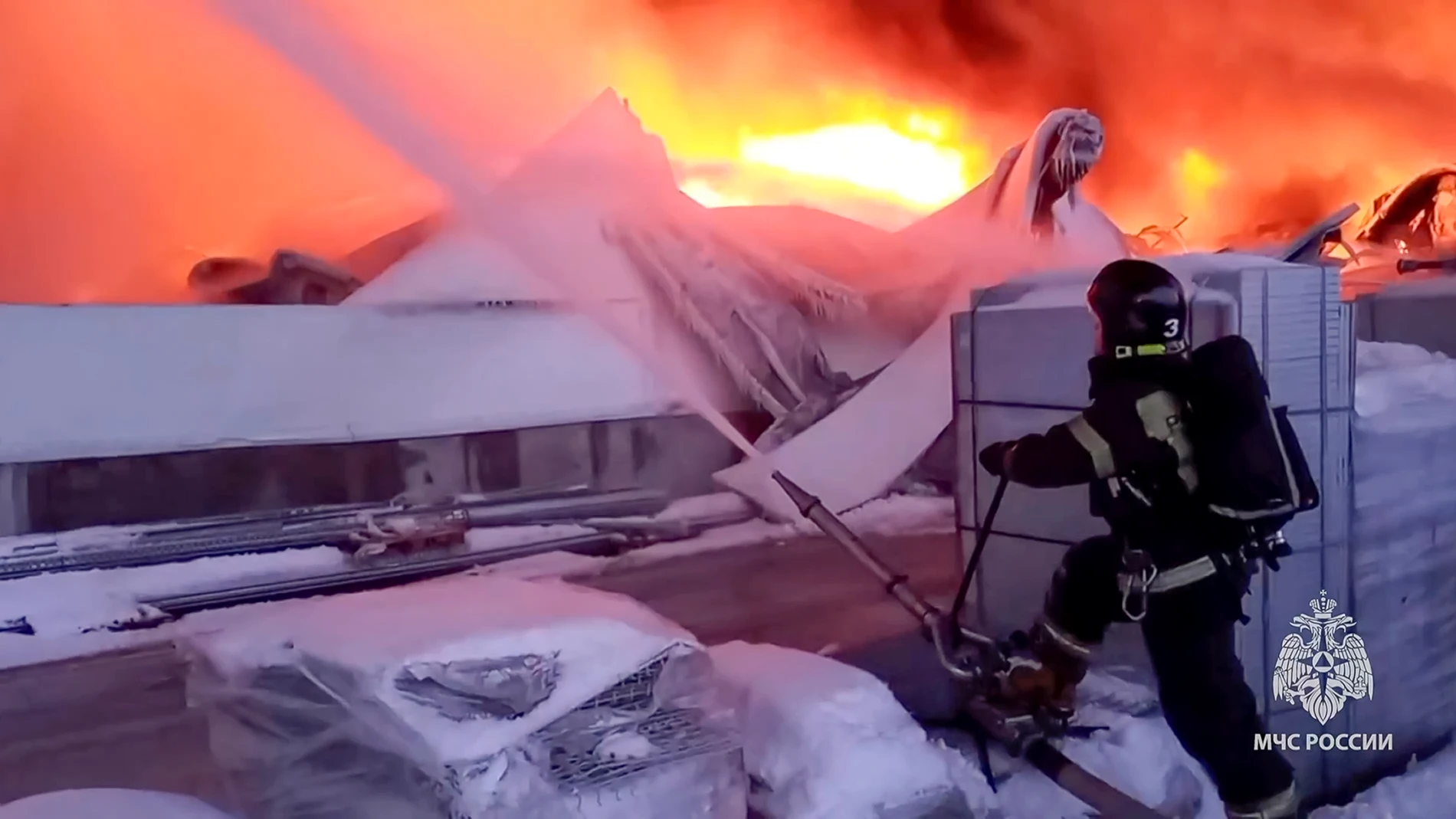 In this photo released by Russian Emergency Ministry Press Service on Saturday, Jan. 13, 2024, A Russian Emergency Situations Ministry firefighter works at the site of the warehouse in St. Petersburg, Russia. Russian authorities say that a huge fire tore through a large warehouse used by Russia's largest online retailer south of St. Petersburg. Russia's Emergency Situations Ministry said the fire covered an area of 70,000 square meters with 50,000 square meters of the warehouse collapsing. No...