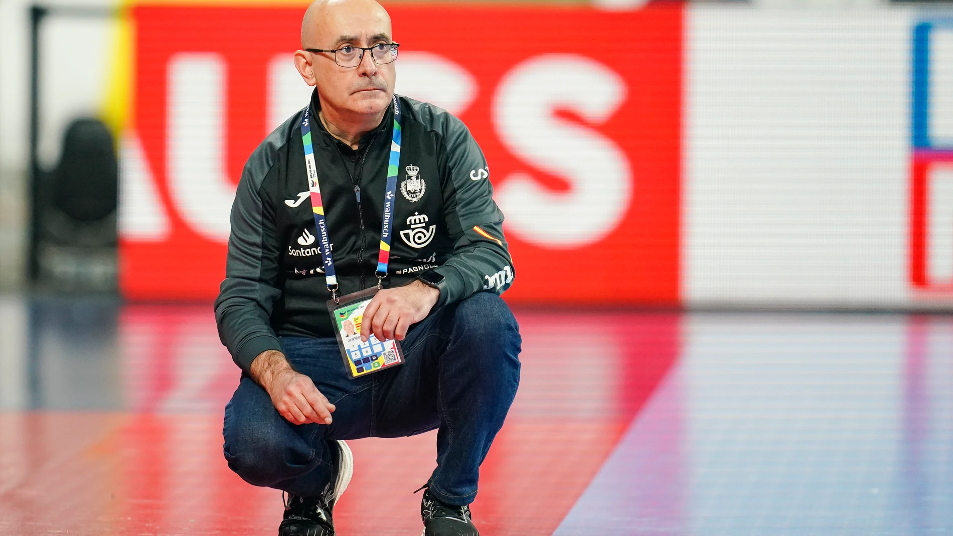 Spain's head coach Jordi Ribera Romans sits on the pitch during the Handball European Championship preliminiary round Group B match between Spain and Austria in Mannheim, Germany, Tuesday, Jan. 16, 2024. (Uwe Anspach/dpa via AP)