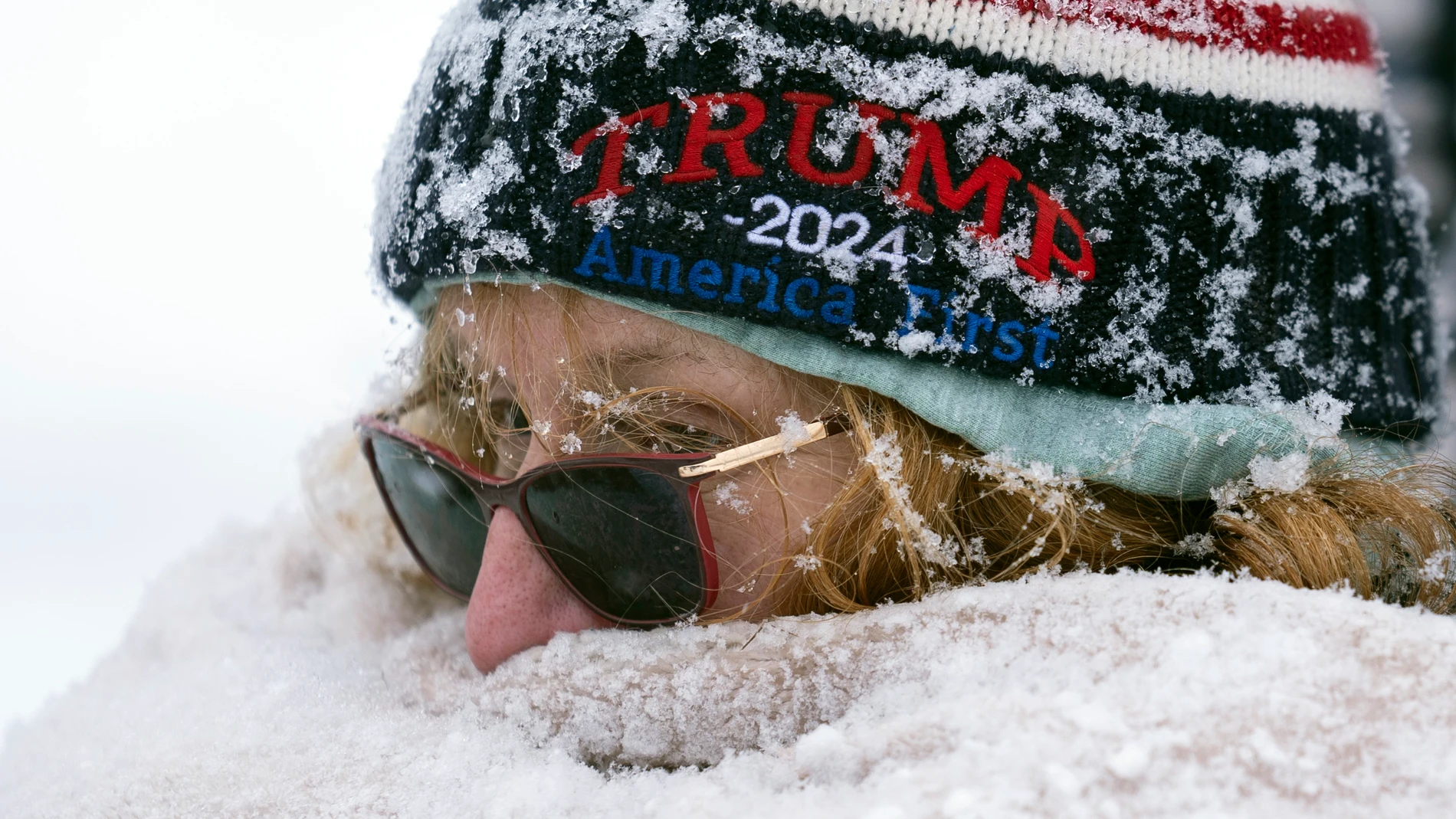A person waits to enter a Republican presidential candidate former President Donald Trump campaign event during a winter snowstorm in Atkinson, N.H., Tuesday, Jan. 16, 2024. (AP Photo/Matt Rourke)