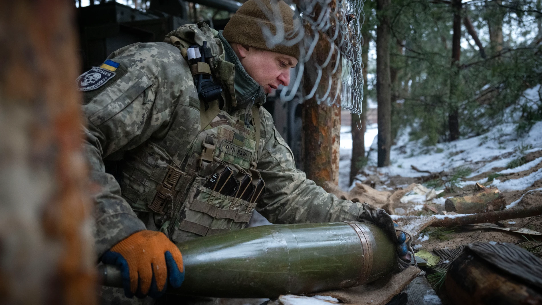 A Ukrainian serviceman prepares to fires a self-propelled howitzer "Bohdana" towards Russian positions near Bakhmut, Ukraine, Donetsk region, Ukraine, Friday, Jan. 26, 2024. (AP Photo/Efrem Lukatsky)