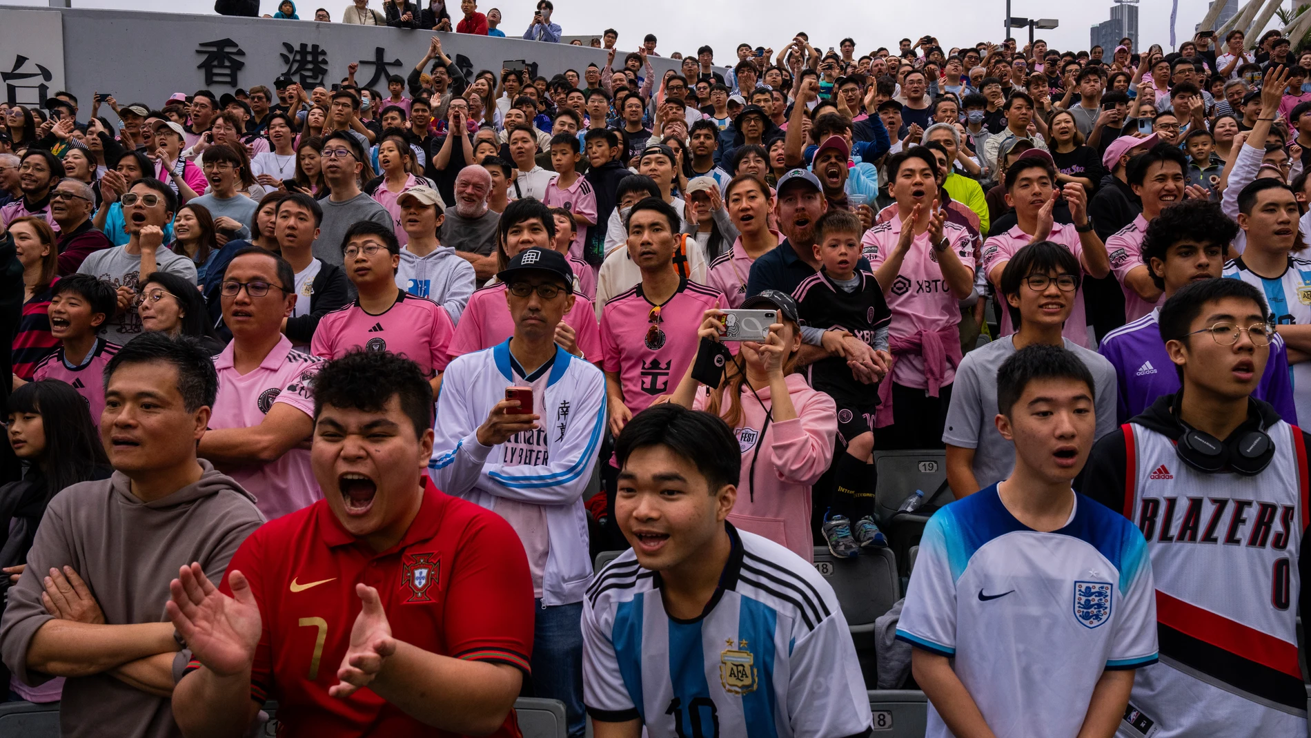 Supporters cheer during the friendly football match between Hong Kong Team and US Inter Miami CF at the Hong Kong Stadium in Hong Kong, Sunday, Feb. 4, 2024. (AP Photo/Louise Delmotte)