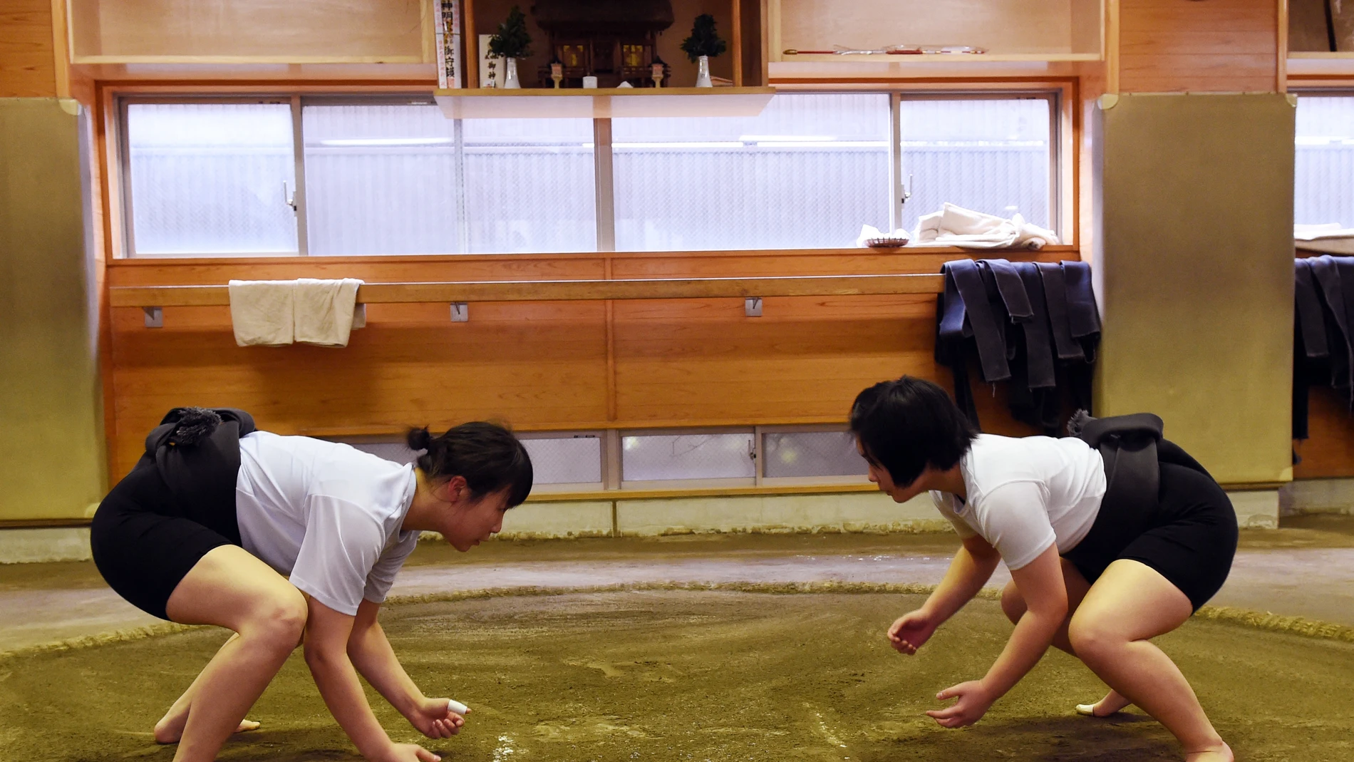 Female sumo wrestler Sayaka Matsuo (R) fights with her teammate Shiori Kanehira (L) during a training session at Nihon University's sumo club in Tokyo.