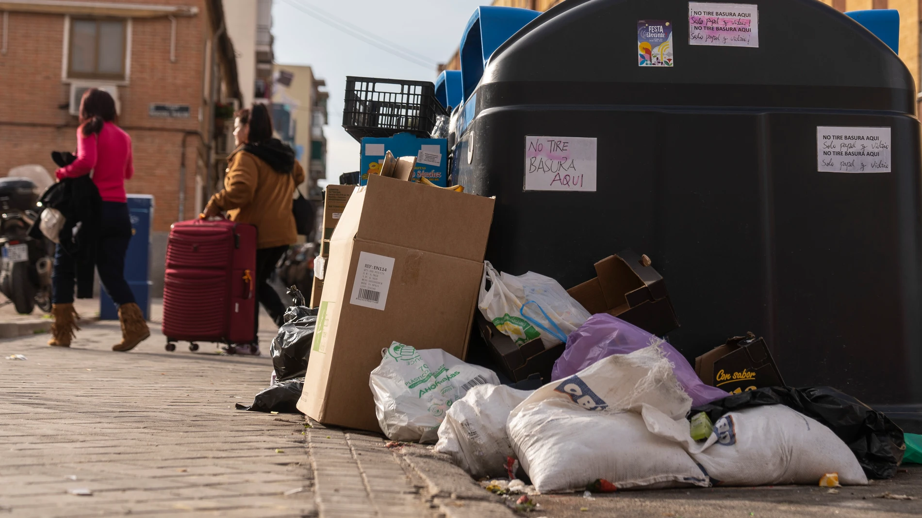 Basura fuera de los cubos en Usera