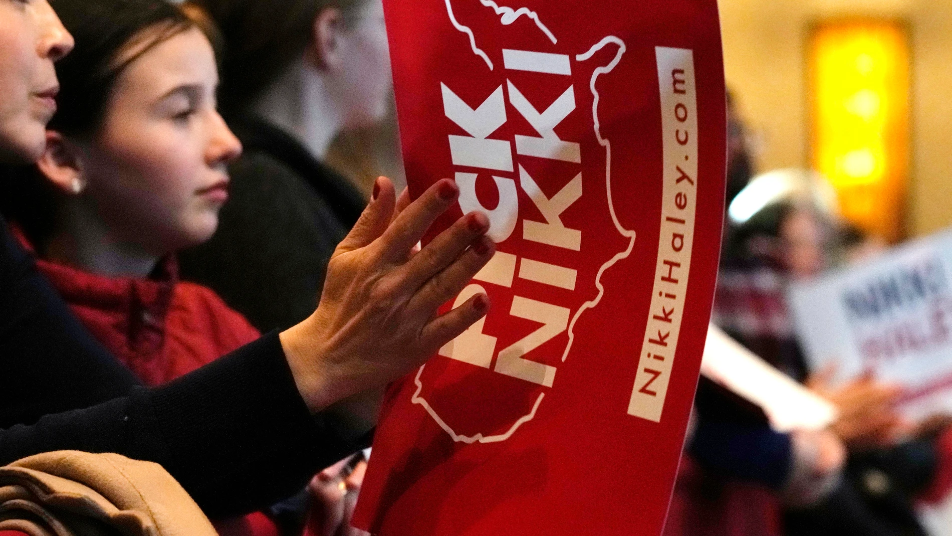 A supporter claps as Republican presidential candidate and former United Nations Ambassador Nikki Haley addresses a campaign event, Sunday, Feb. 25, 2024, in Troy, Mich. (AP Photo/Carlos Osorio)
