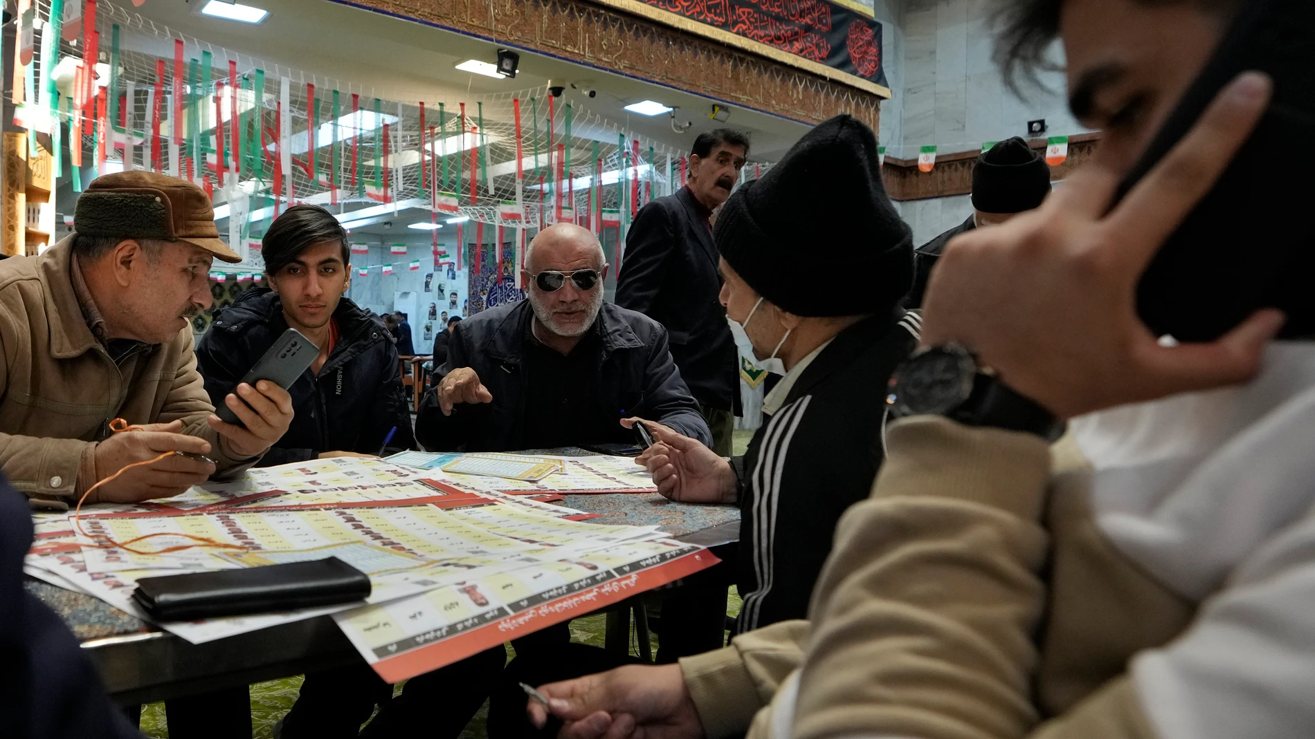 Voters fill out their ballots during the parliamentary and Assembly of Experts elections at a polling station in Tehran, Iran, Friday, March 1, 2024. Iran on Friday held the country's first election since the mass 2022 protests over mandatory hijab laws after the death in police custody of Mahsa Amini, with questions looming over just how many people will turn out at the polls. (AP Photo/Vahid Salemi)