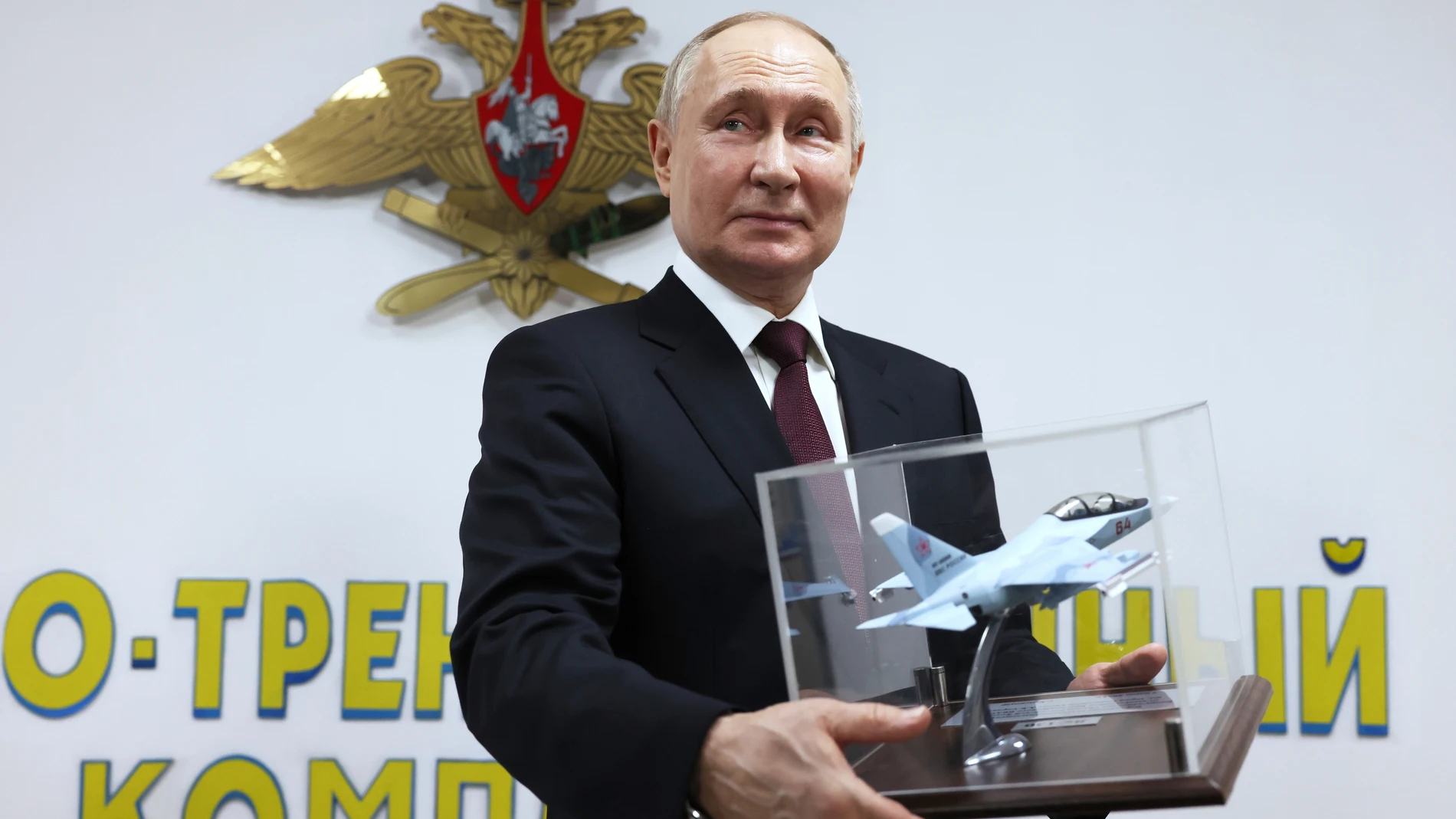 Russian President Vladimir Putin is presented with a memorable gift during a visit to the Krasnodar Higher Military Aviation School of Pilots named after Anatoly Serov in Krasnodar, Russia, Thursday, March 7, 2024. (Mikhail Metzel, Sputnik, Kremlin Pool Photo via AP)