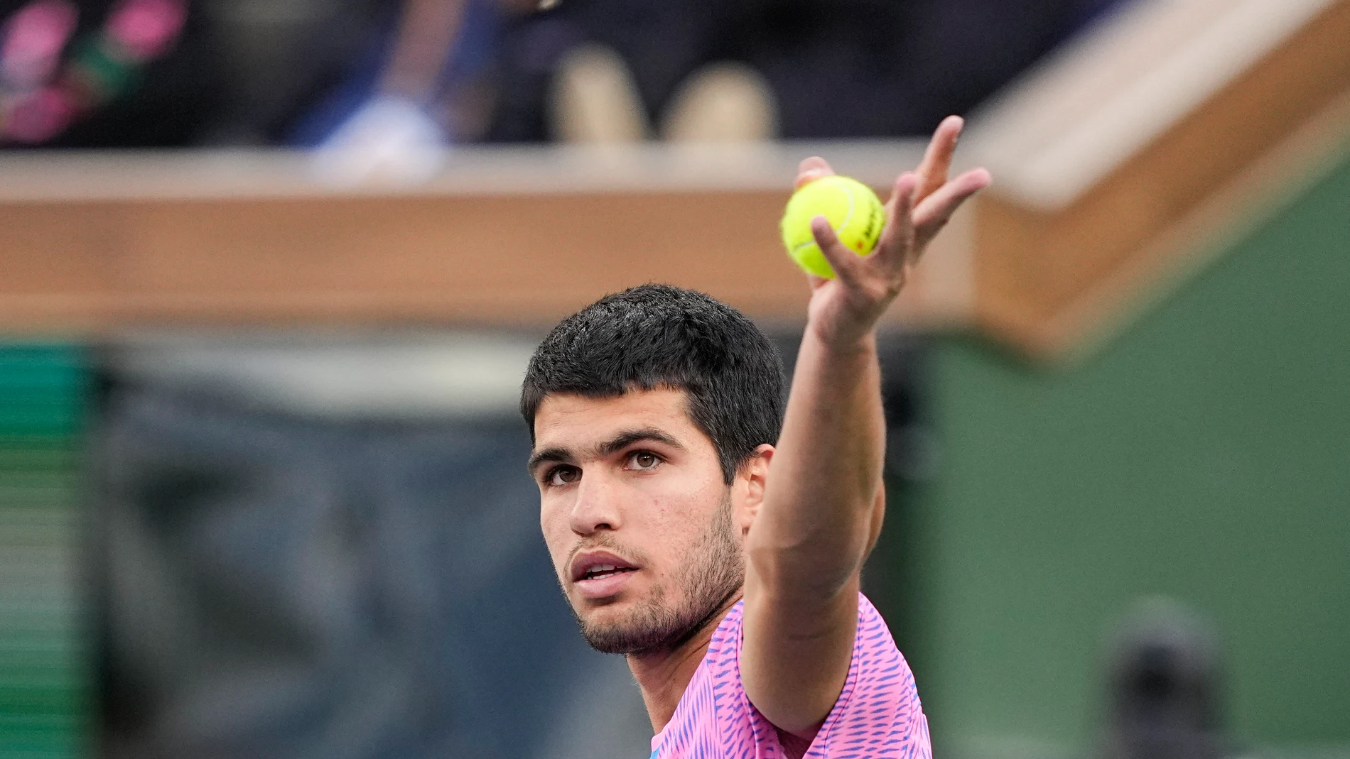 Carlos Alcaraz, of Spain, swats away a bee as he plays Alexander Zverev, of Germany, during a quarterfinal match at the BNP Paribas Open tennis tournament, Thursday, March 14, 2024, in Indian Wells, Calif. (AP Photo/Mark J. Terrill)