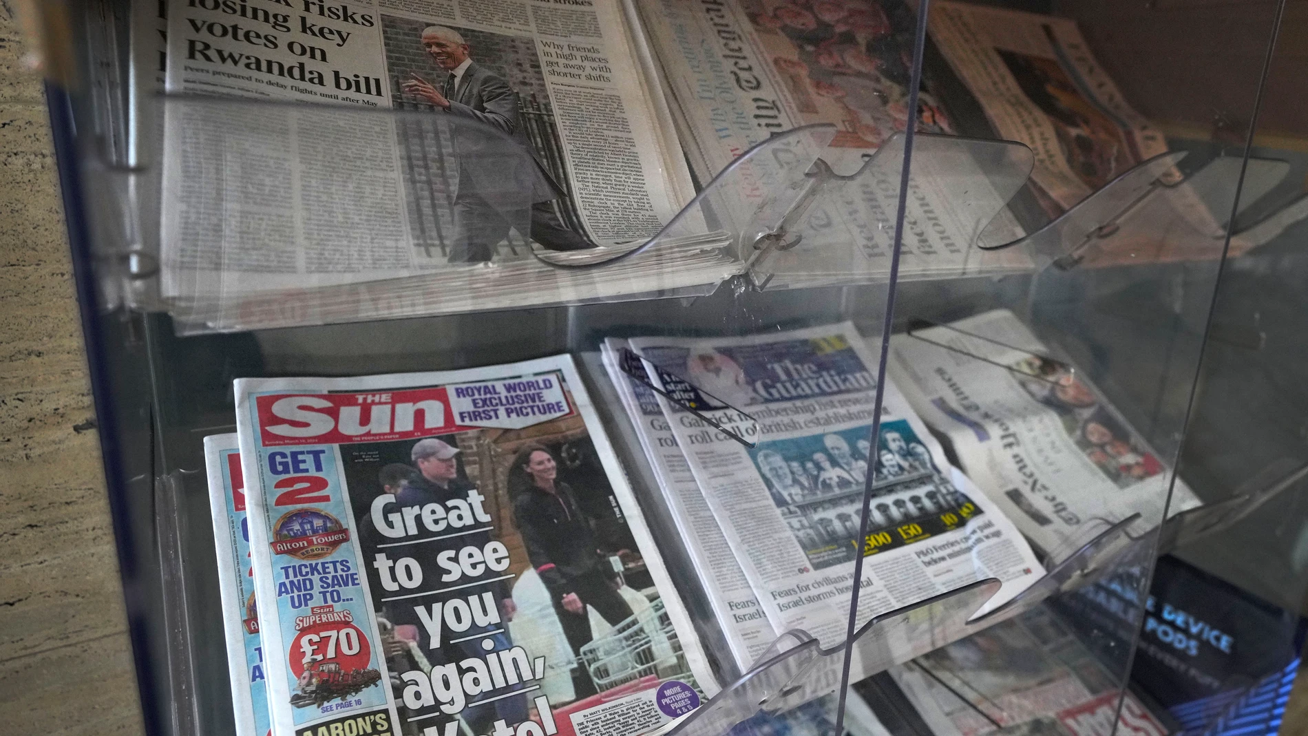 Newspapers on display for sale, in London, Tuesday, March 19, 2024. A British newspaper says Prince William and his wife Catherine have been filmed at a farm shop near their Windsor home. It's the first reported footage of Kate since she had abdominal surgery for an unspecified condition two months ago. The Sun published a short clip late Monday that appeared to show the couple smiling as they walked together, carrying shopping bags. It said the footage was taken on Saturday. (AP Photo/Kirsty...
