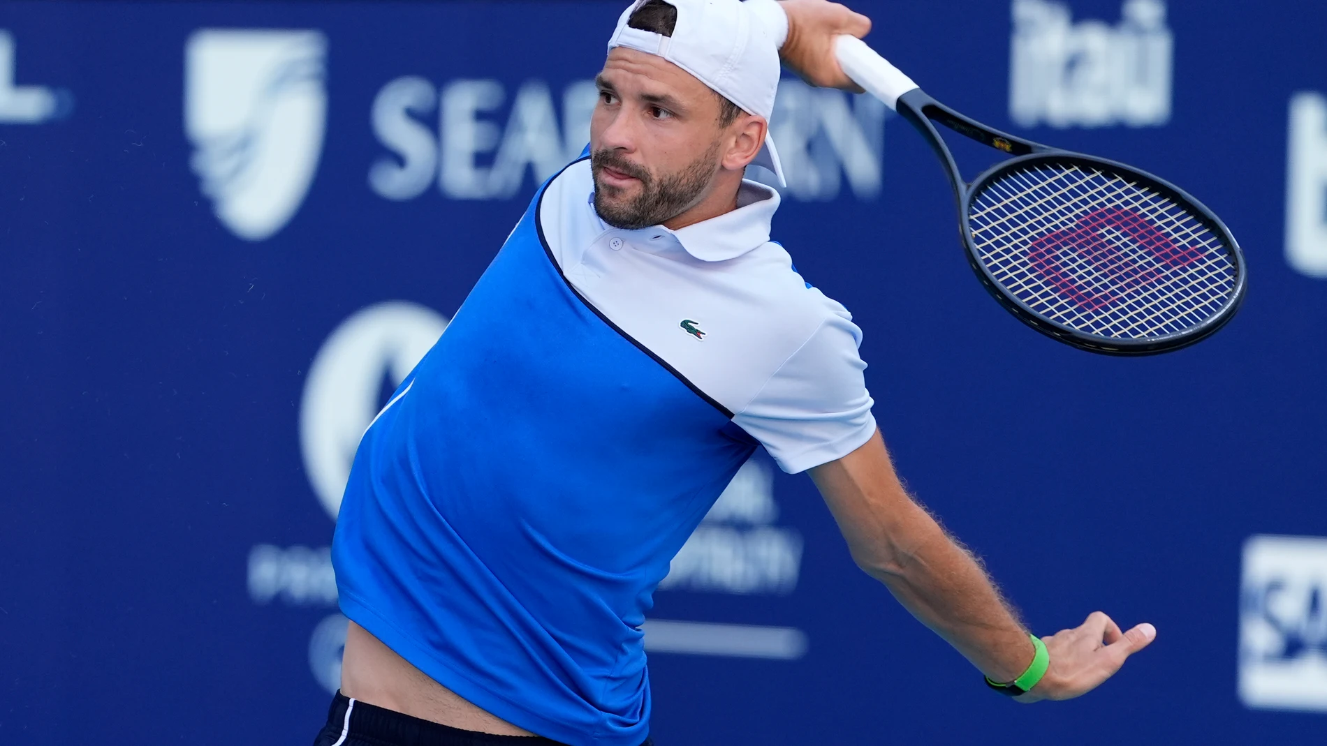 Grigor Dimitrov, of Bulgaria, follows through on a return to Jannik Sinner, of Italy, during the men's final at the Miami Open tennis tournament Sunday, March 31, 2024, in Miami Gardens, Fla. (AP Photo/Lynne Sladky)