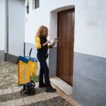 Una cartera de Correos haciendo el reparto en un pueblo