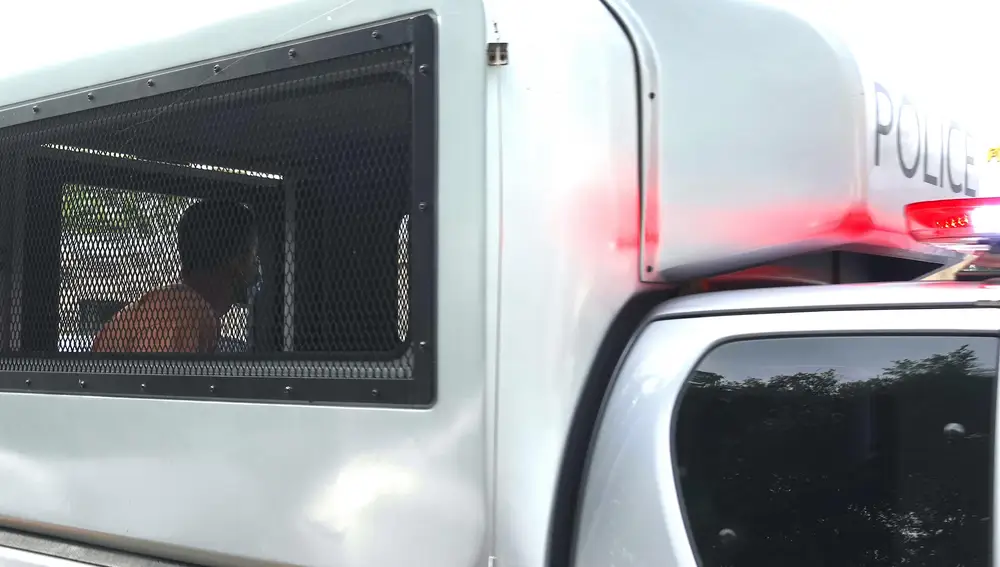 Spanish chef, Daniel Sancho Bronchalo (L), accused of murder sits inside a prisoner transportation vehicle, as arrives for a hearing on his trial at the Koh Samui Provincial Court in Koh Samui island, Thailand