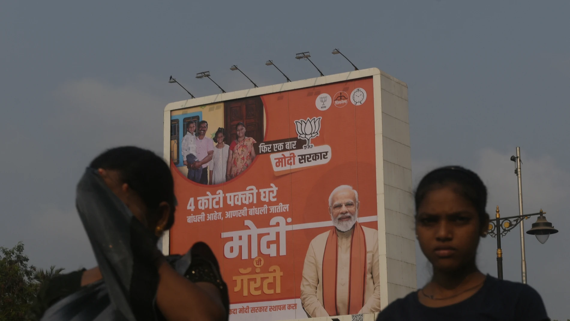 Commuters are passing by Prime Minister Narendra Modi's poster ahead of the Lok Sabha election in Mumbai, India, on April 17, 2024.