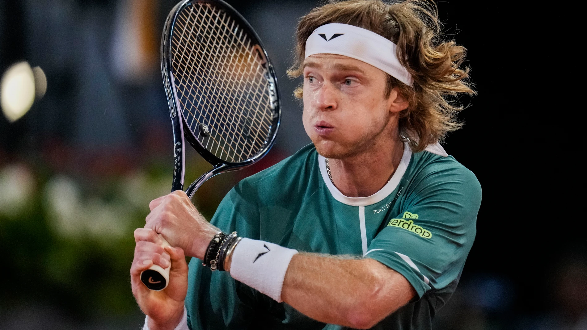 Andrey Rublev, of Russia, returns the ball to Carlos Alcaraz, of Spain, during the Mutua Madrid Open tennis tournament in Madrid, Wednesday, May 1, 2024. (AP Photo/Manu Fernandez)