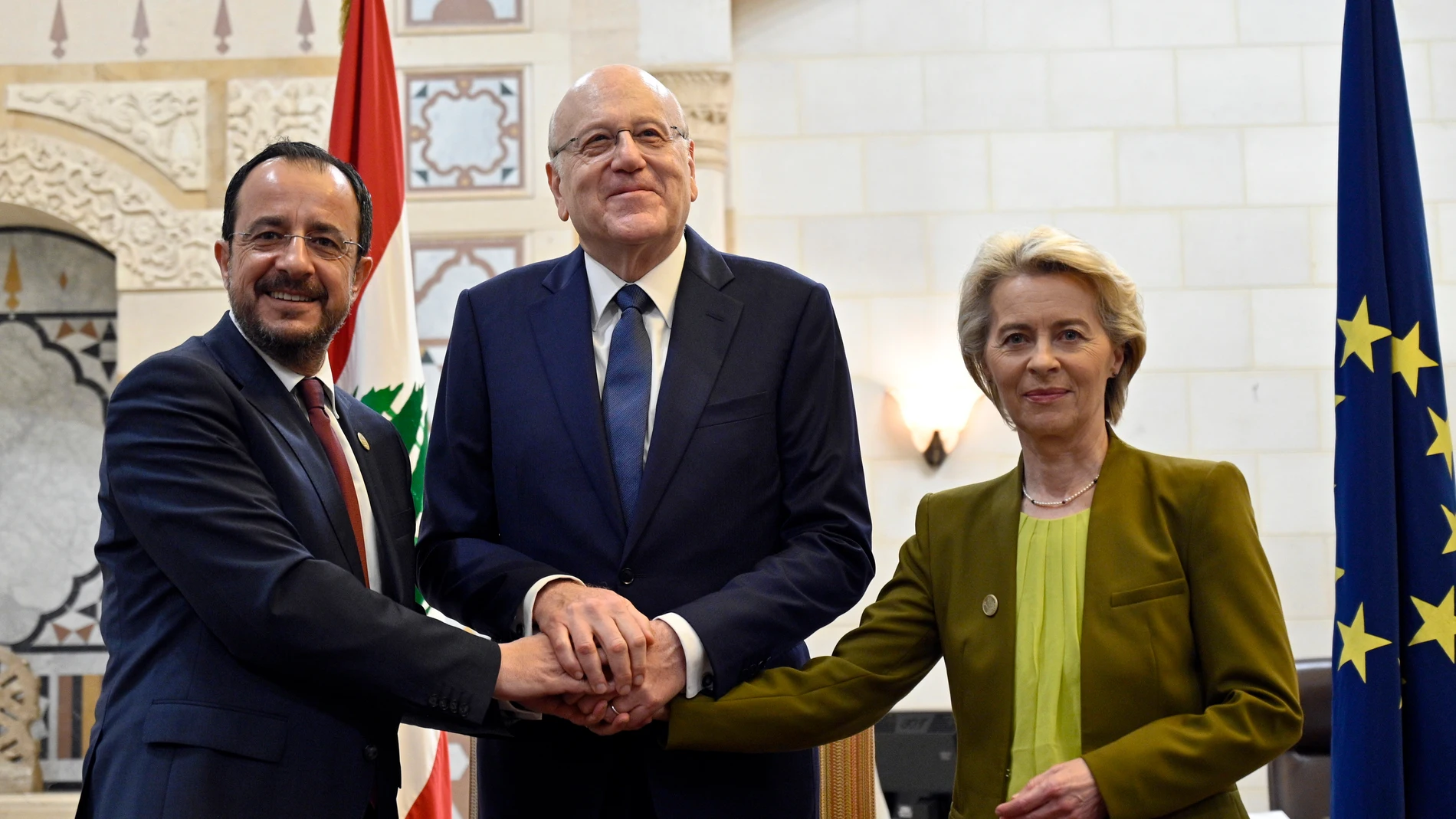Beirut (Lebanon), 02/05/2024.- Lebanese caretaker Prime Minister Najib Mikati (C) shakes hands with Cypriot President Nikos Christodoulides (L) and European Commission President Ursula von der Leyen (R) during their meeting at the Government Palace in downtown Beirut, Lebanon, 02 May 2024. The president of Cyprus and the European Commission president are both in Beirut to talk about the current surge in Syrian refugee immigration. Around 2,140 people arrived by boat in Cyprus between 01 Janua...
