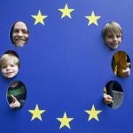 Visitors pose for a picture with EU flag during the open days of European institutions on 'Europe Day' in Brussels, Belgium.