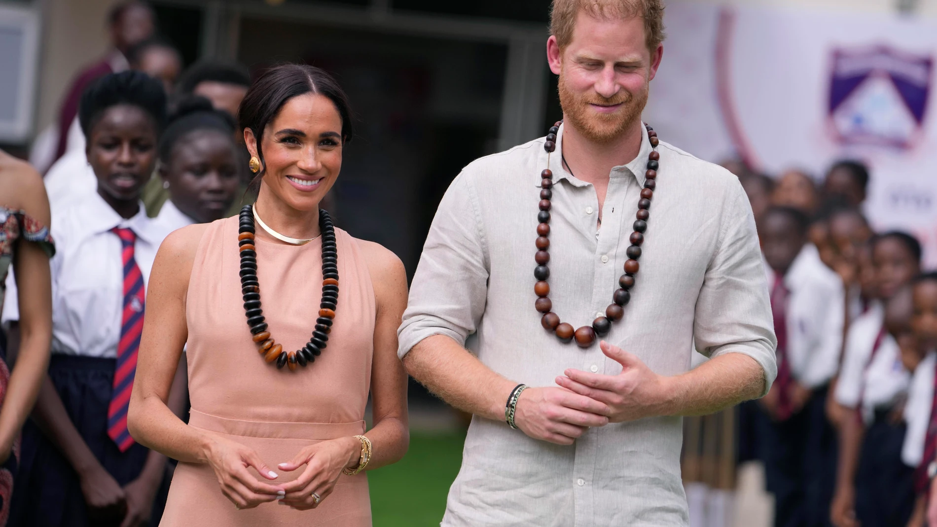 Prince Harry and Meghan visit children at the Lights Academy in Abuja, Nigeria, Friday, May 10, 2024. Prince Harry and his wife Meghan have arrived in Nigeria to champion the Invictus Games, which he founded to aid the rehabilitation of wounded and sick servicemembers and veterans. (AP Photo/Sunday Alamba)