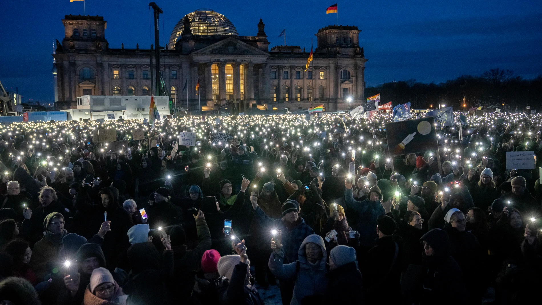 FILE - People hold up their cell phones as they protest the far-right Alternative for Germany, or AfD party, and right-wing extremism in front of the parliament building in Berlin, Germany, on Jan. 21, 2024. (AP Photo/Ebrahim Noroozi, File)