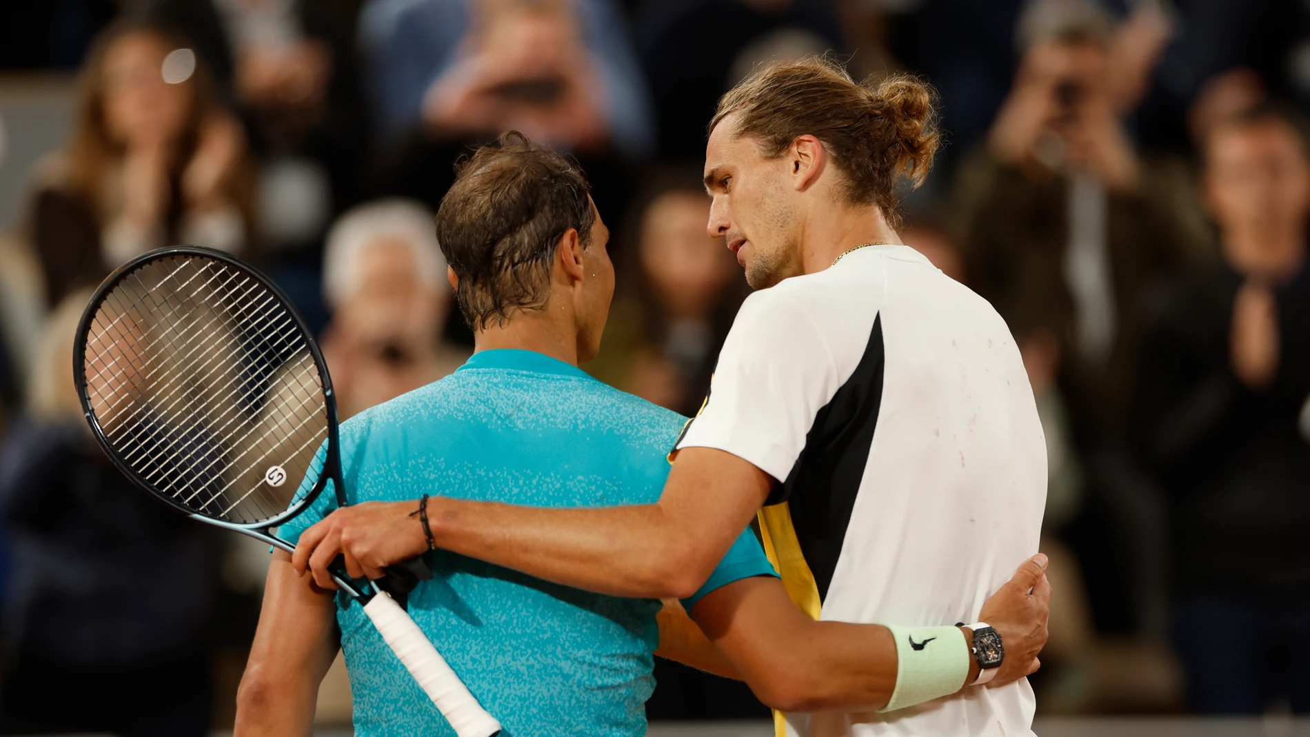 Germany's Alexander Zverev, right, speaks with Spain's Rafael Nadal after winning the game during their first round match of the French Open tennis tournament at the Roland Garros stadium in Paris, Monday, May 27, 2024. (AP Photo/Jean-Francois Badias)