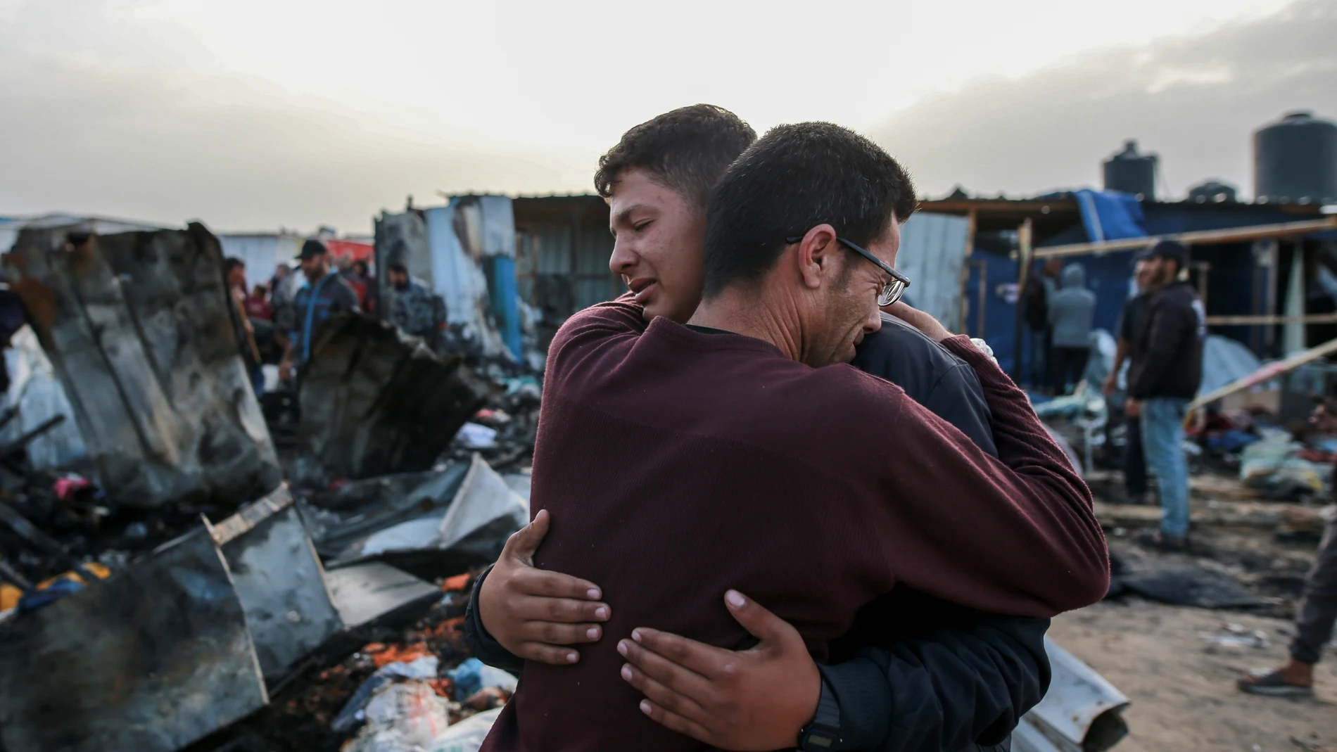 Palestinians react next to the destruction after an Israeli strike where displaced people were staying in Rafah, Gaza Strip, Monday, May 27, 2024. Palestinian health workers said Israeli airstrikes killed at least 35 people in the area. Israel's army confirmed Sunday's strike and said it hit a Hamas installation and killed two senior Hamas militants. (AP Photo/Jehad Alshrafi)