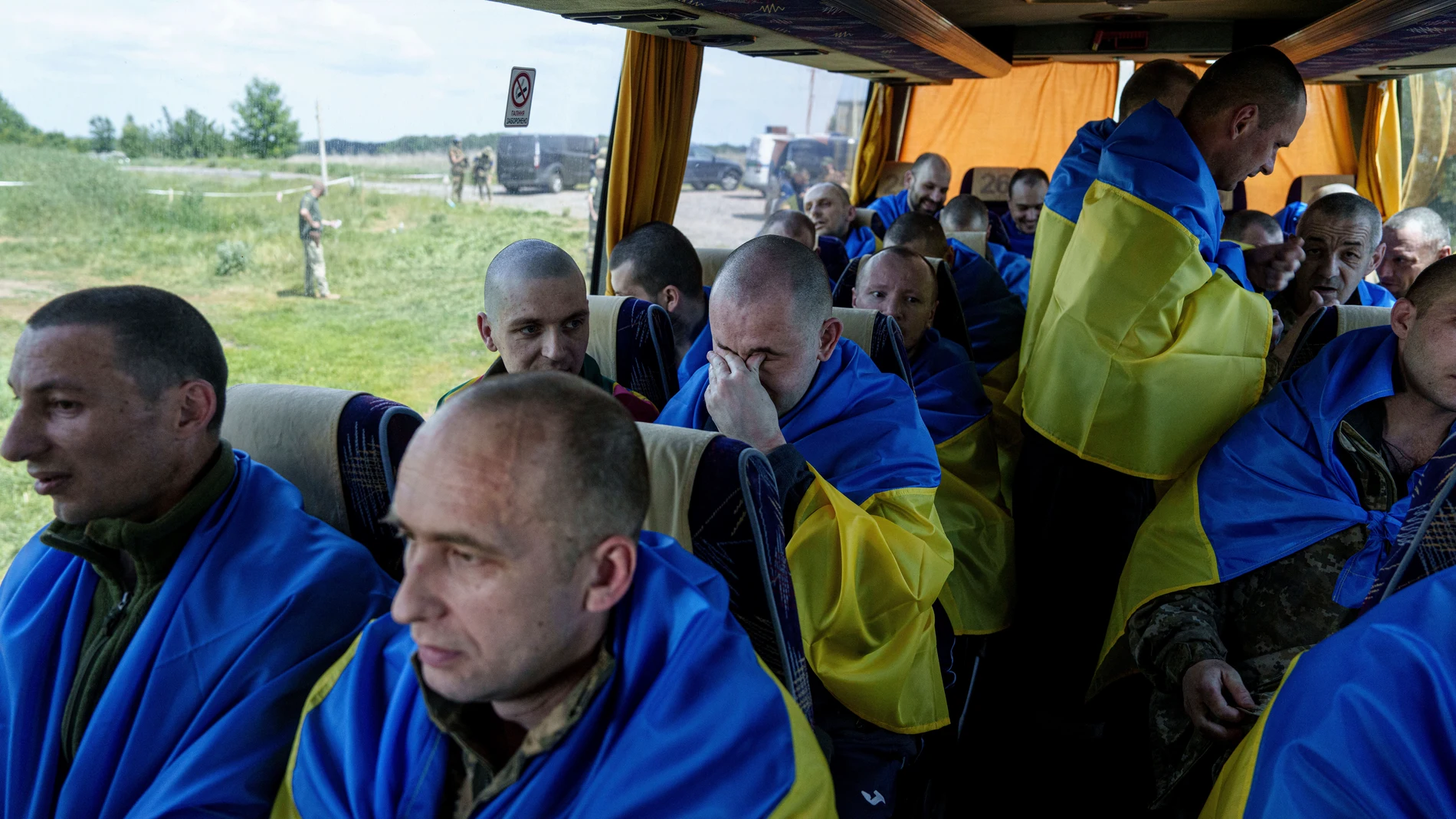 Ukrainian servicemen sit in a bus after returning from captivity during POWs exchange in Sumy region, Ukraine, Friday, May 31, 2024. Ukraine returned 75 prisoners, including four civilians, in the latest exchange of POWs with Russia. It's the fourth prisoner swap this year, and 52nd since Russia invaded Ukraine. In all, 3 210 Ukrainian servicemen and civilians were returned since the outbreak of the war. (AP Photo/Evgeniy Maloletka)