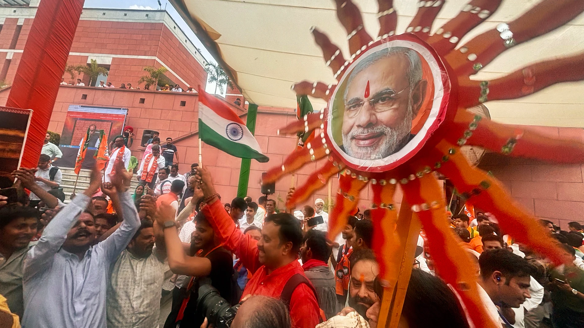 Bharatiya Janata Party (BJP) supporters dance inside the party office after hearing of a candidate's victory during the counting in India's national election, in New Delhi, India, Tuesday, June 4, 2024. Prime Minister Narendra Modi's Hindu nationalist party showed a comfortable lead Tuesday, according to early figures reported by India's Election Commission, but was facing a stronger challenge from the opposition than had been expected. (AP Photo/Manish Swarup)