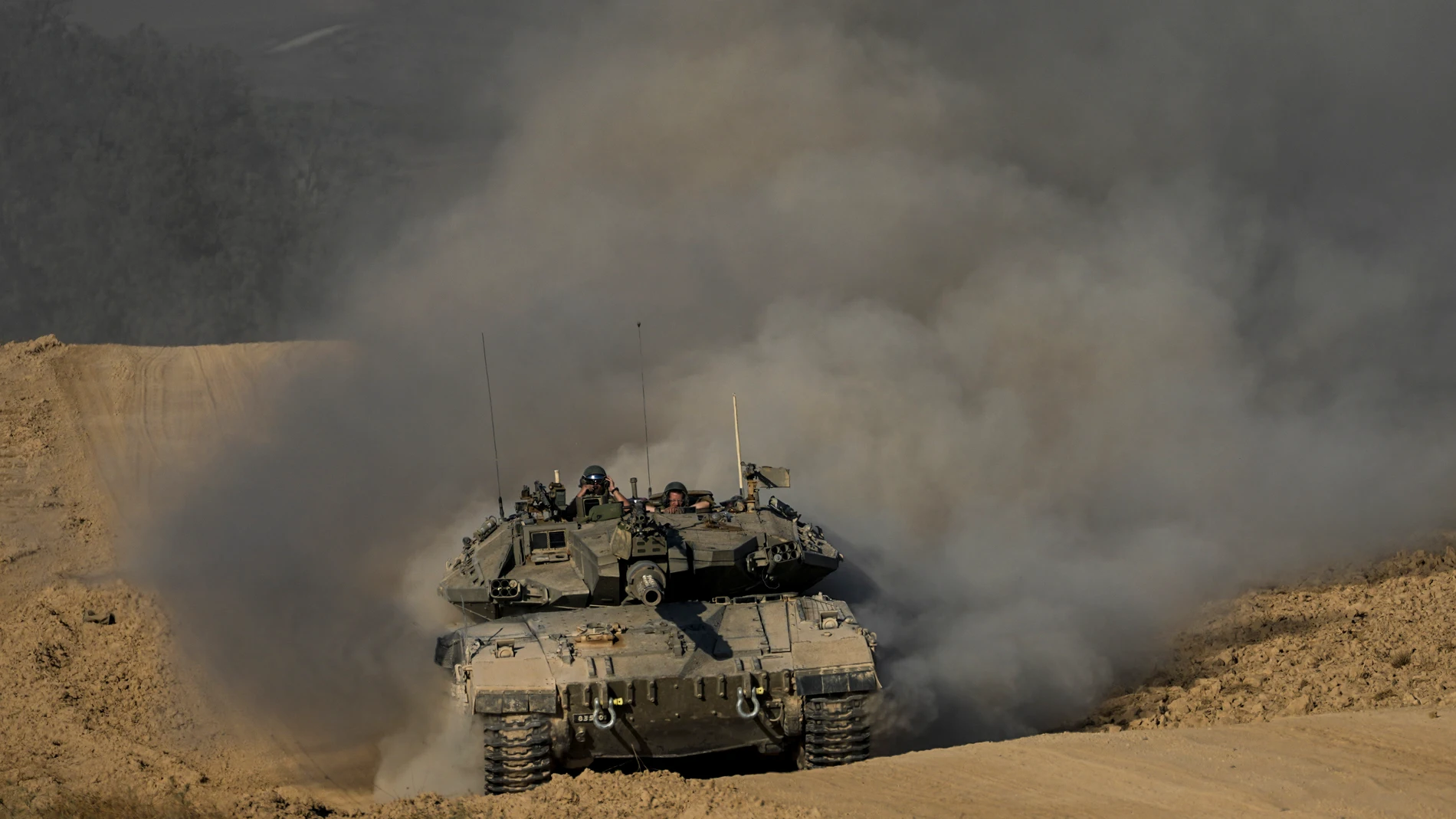 Israeli soldiers drive a tank near the Israeli-Gaza border, in southern Israel, Wednesday, June 5, 2024. (AP Photo/Tsafrir Abayov)