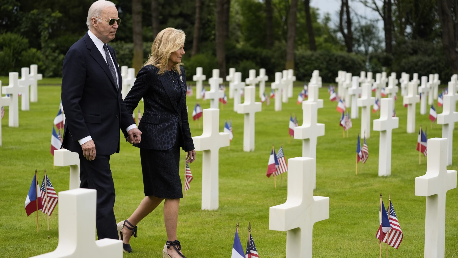 President Joe Biden and first lady Jill Biden walk in the Normandy American Cemetery following a ceremony to mark the 80th anniversary of D-Day, Thursday, June 6, 2024, in Normandy. (AP Photo/Evan Vucci)
