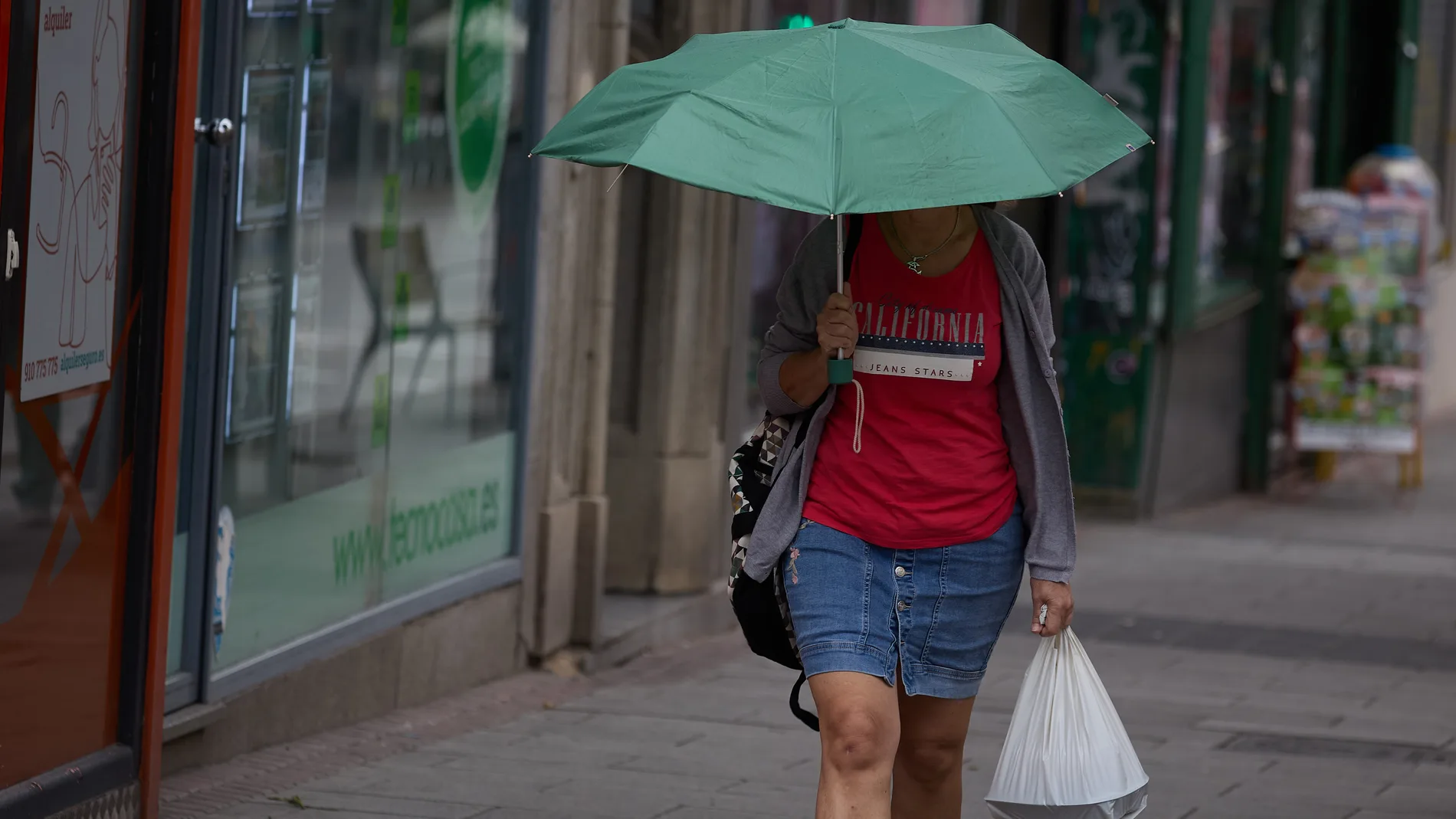 Una mujer se protege de la lluvia con un paraguas, a 8 de junio de 2024, en Madrid (España). La llegada de una Depresión Aislada en Niveles Altos (DANA) a España va a provocar durante el fin de semana y hasta el jueves de la semana que viene un episodio de chubascos casi generalizados en la Península y una bajada de las temperaturas de más de 10ºC, según la Agencia Estatal de Meteorología (AEMET). 08 JUNIO 2024;LLUVIA;DANA;TIEMPO;METEOROLOGÍA;PRECIPITACIONES;AEMET Jesús Hellín / Europa Pr...