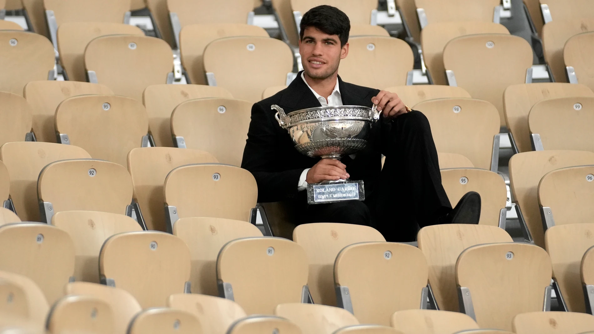 Spain's Carlos Alcaraz holds the trophy as he poses for media after the French Open tennis tournament at the Roland Garros stadium in Paris, Monday, June 10, 2024. Alcaraz won the title on Sunday in the final against Germany's Alexander Zverev. (AP Photo/Christophe Ena)