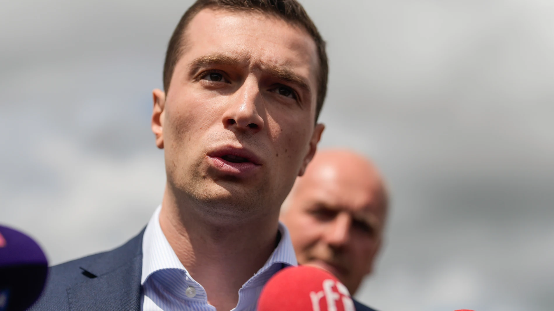 Jordan Bardella far-right National Rally leader for the upcoming election speaks to the media as he visits a farm in Chuelles, 137 kms (85 miles) south of Paris, Friday, June 14, 2024. The election is to take place in two rounds on June 30 and July 7. (AP Photo/Thibault Camus)