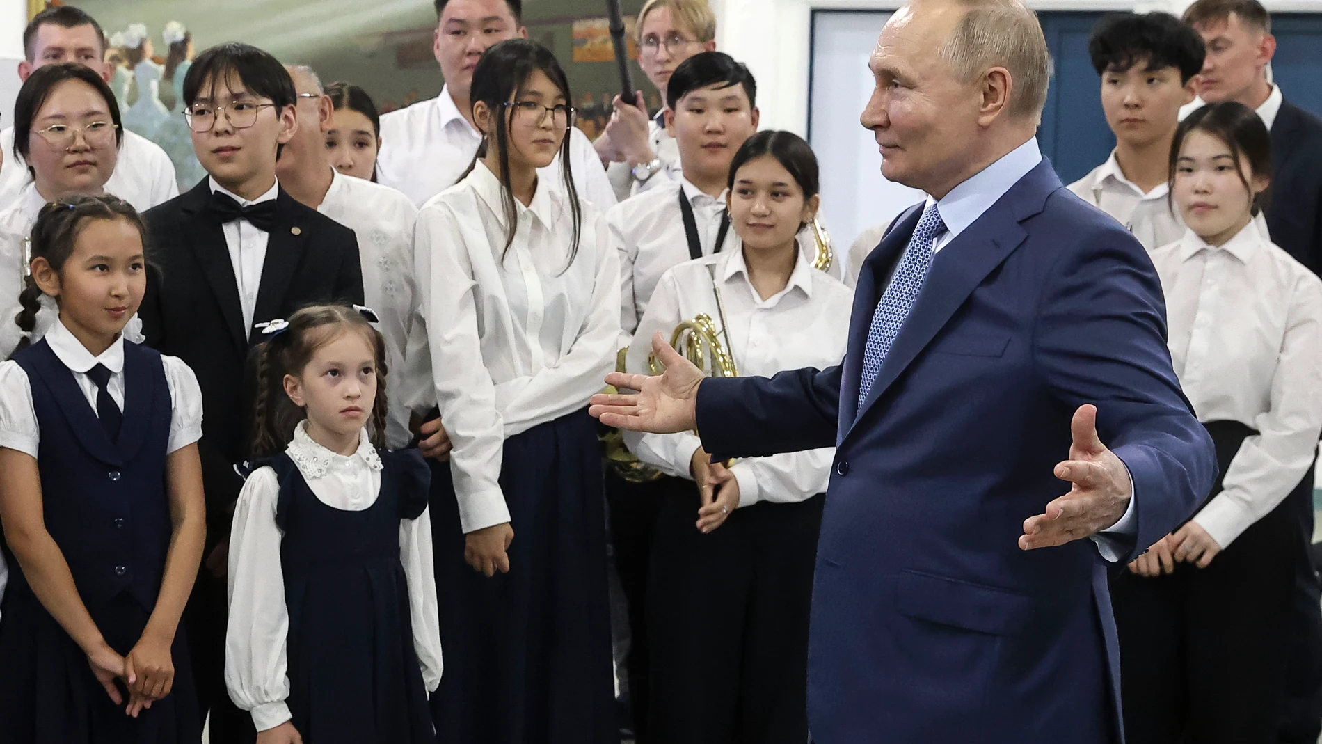 Russian President Vladimir Putin, right, gestures while visiting the school of music during his working visit to Yakutsk, republic of Sakha also known as Yakutia, Russia Far East, Russia, Tuesday, June 18, 2024. (Sergei Karpukhin, Sputnik, Kremlin Pool Photo via AP)