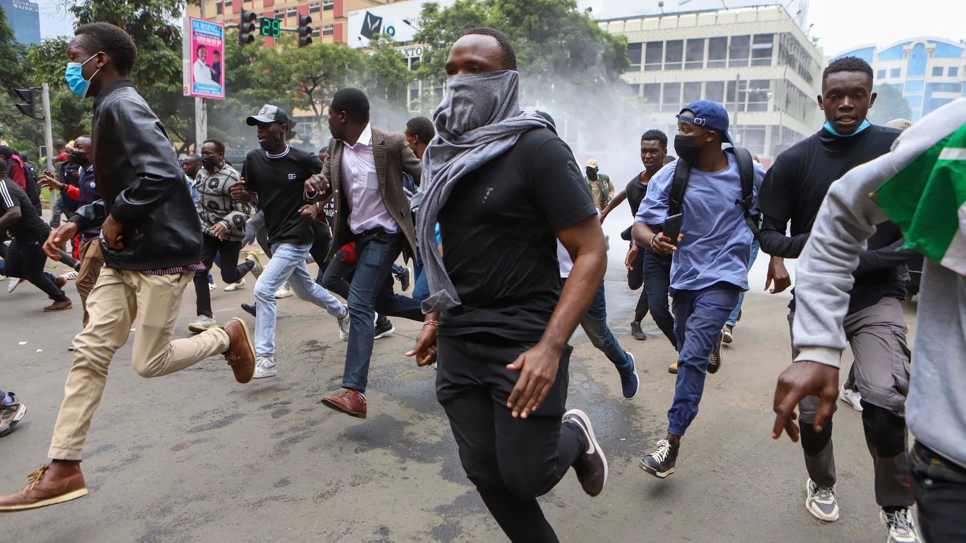 Demonstrators run from police during a protest over proposed tax hikes in a finance bill that is due to be tabled in parliament in Nairobi, Kenya, Thursday, June 20, 2024. AP Photo/ Andrew Kasuku)