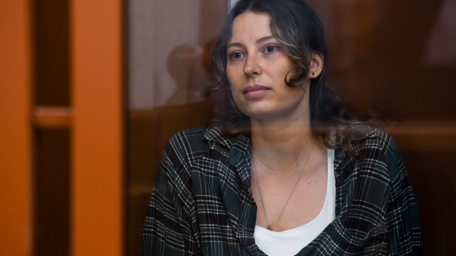 Ksenia Karelina, also known as Khavana sits in a glass cage in a court room in Yekaterinburg, Russia, Thursday, June 20, 2024. The trial of a woman with dual US-Russian citizenship on charges of treason opened on Thursday amid rising tensions between Washington and Moscow including the arrests of two American journalists. (AP Photo)