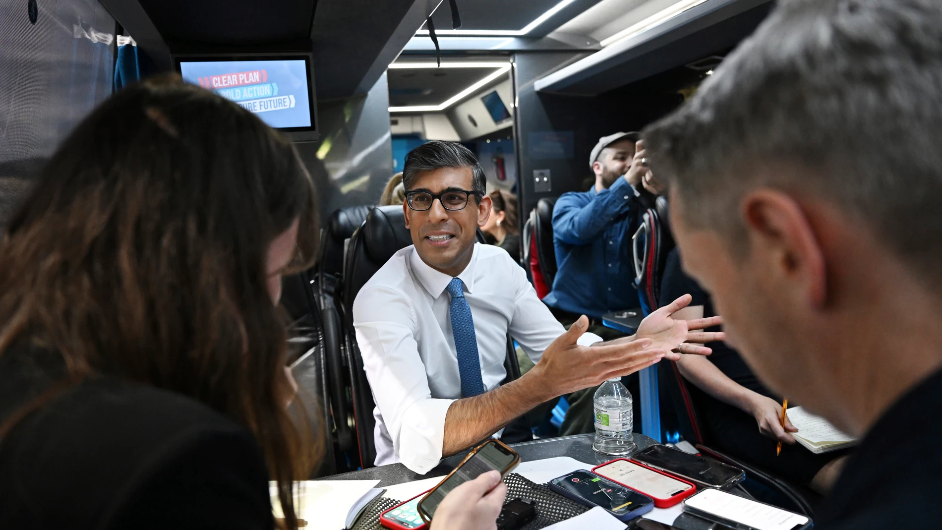 Britain's Prime Minister Rishi Sunak speaks to journalists on the campaign bus following the launch of the Welsh Conservatives General Election manifesto near Rhyl, Wales, England, Friday June 21, 2024. (Leon Neal/Pool Photo via AP)
