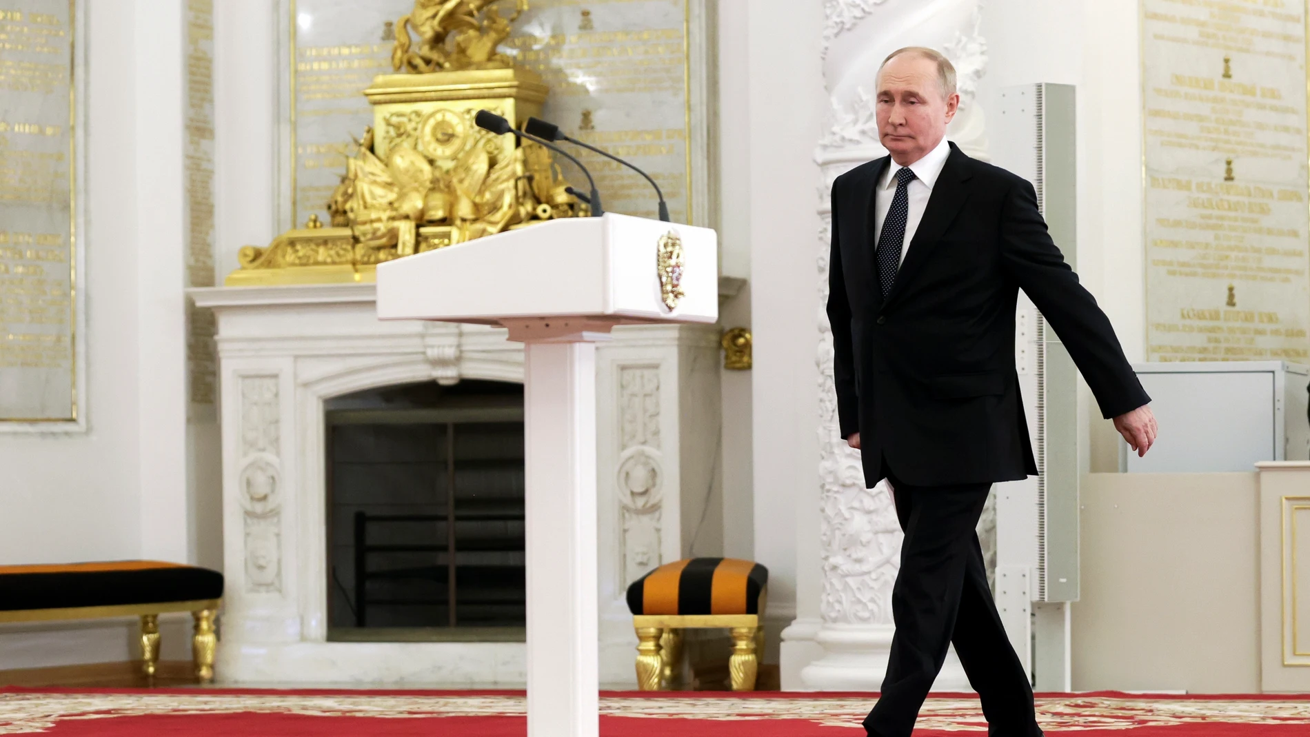 Russian President Vladimir Putin arrives to deliver his speech at a ceremony to congratulate graduates of higher military schools of the Defence and Emergencies ministries, the Federal Security Service, the Federal Guard Service, the Federal Service of National Guard Troops, the Interior Ministry, the Investigative Committee, and the Federal Penitentiary Service at the Kremlin's St. George Hall in Moscow, Russia, Friday, June 21, 2024. (Mikhail Sinitsyn, Sputnik, Kremlin Pool Photo via AP)