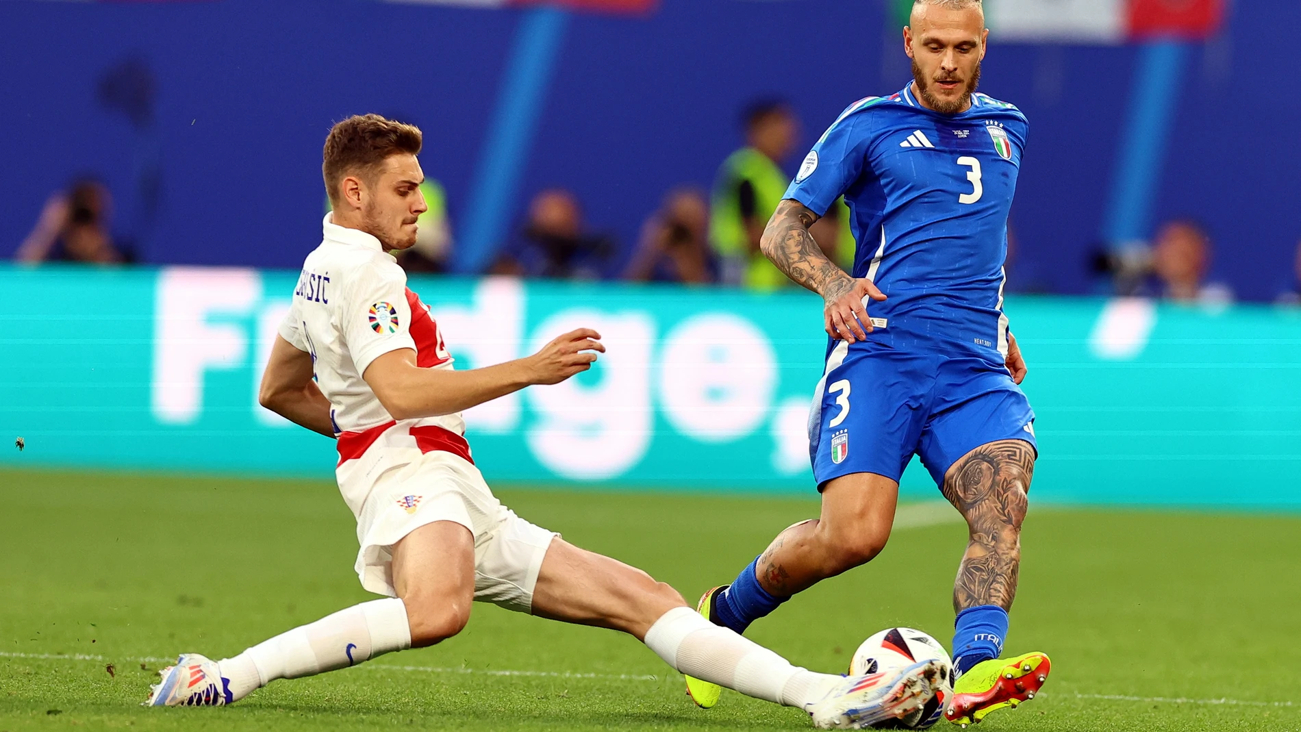 Stanišić y Dimarco en la disputa del balón