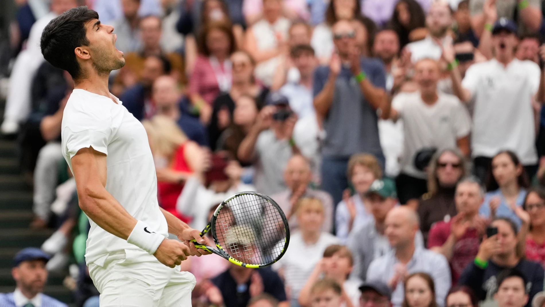 Spain's Carlos Alcaraz reacts after winning a point against Francis Tiafoe of the United States during their third round match at the Wimbledon tennis championships in London, Friday, July 5, 2024. (AP Photo/Alberto Pezzali)