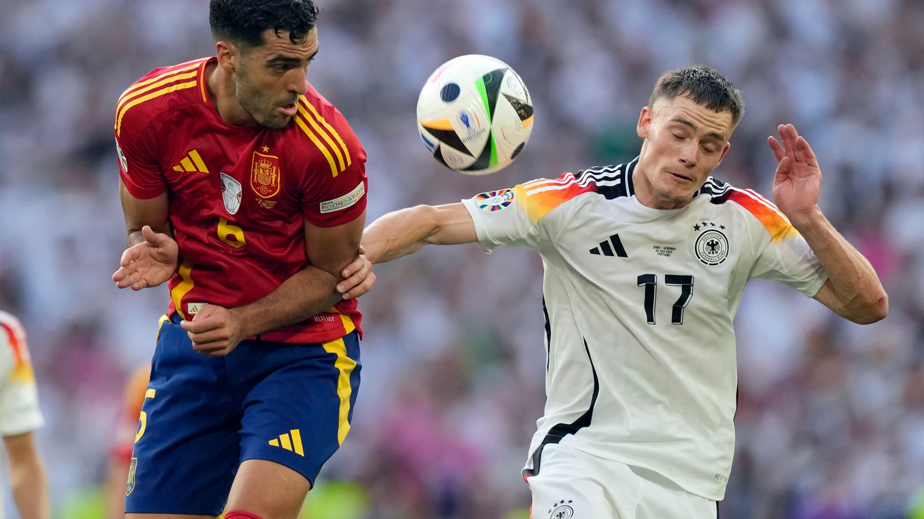 Spain's Mikel Merino, left, and Germany's Florian Wirtz battle for the ball during a quarter final match between Germany and Spain at the Euro 2024 soccer tournament in Stuttgart, Germany, Friday, July 5, 2024. (AP Photo/Antonio Calanni)