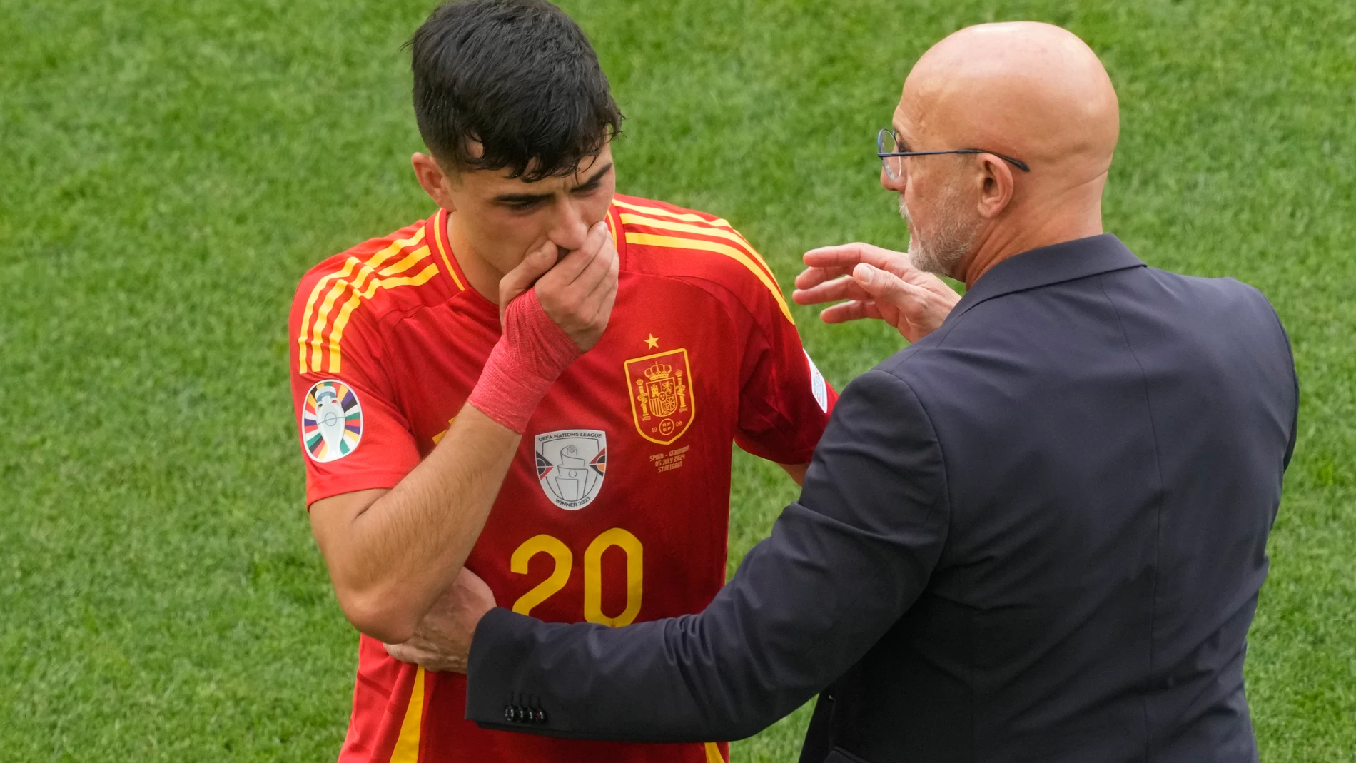 Spain's head coach Luis de la Fuente, right, shows concern for Spain's Pedri after he got hurt during a quarter final match between Germany and Spain at the Euro 2024 soccer tournament in Stuttgart, Germany, Friday, July 5, 2024. (AP Photo/Michael Probst)