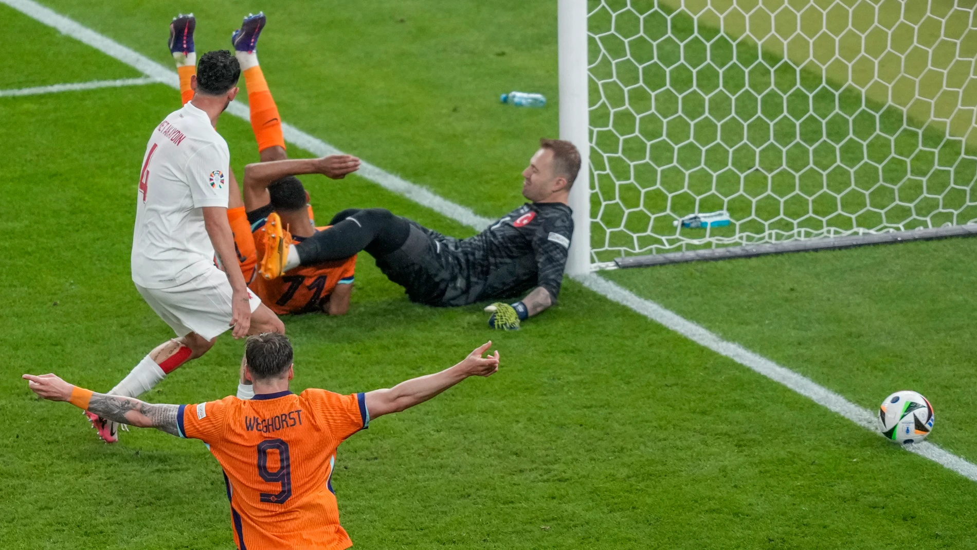 Cody Gakpo of the Netherlands, top second left, scores his sides second goal past Turkey's goalkeeper Mert Gunok during a quarterfinal match between the Netherlands and Turkey at the Euro 2024 soccer tournament in Berlin, Germany, Saturday, July 6, 2024. (AP Photo/Markus Schreiber)