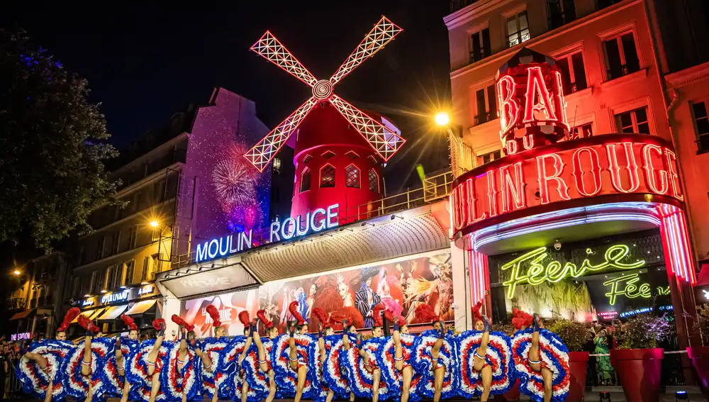 Open air French Can Can performance at the Moulin Rouge to celebrate the return of its windmill blades