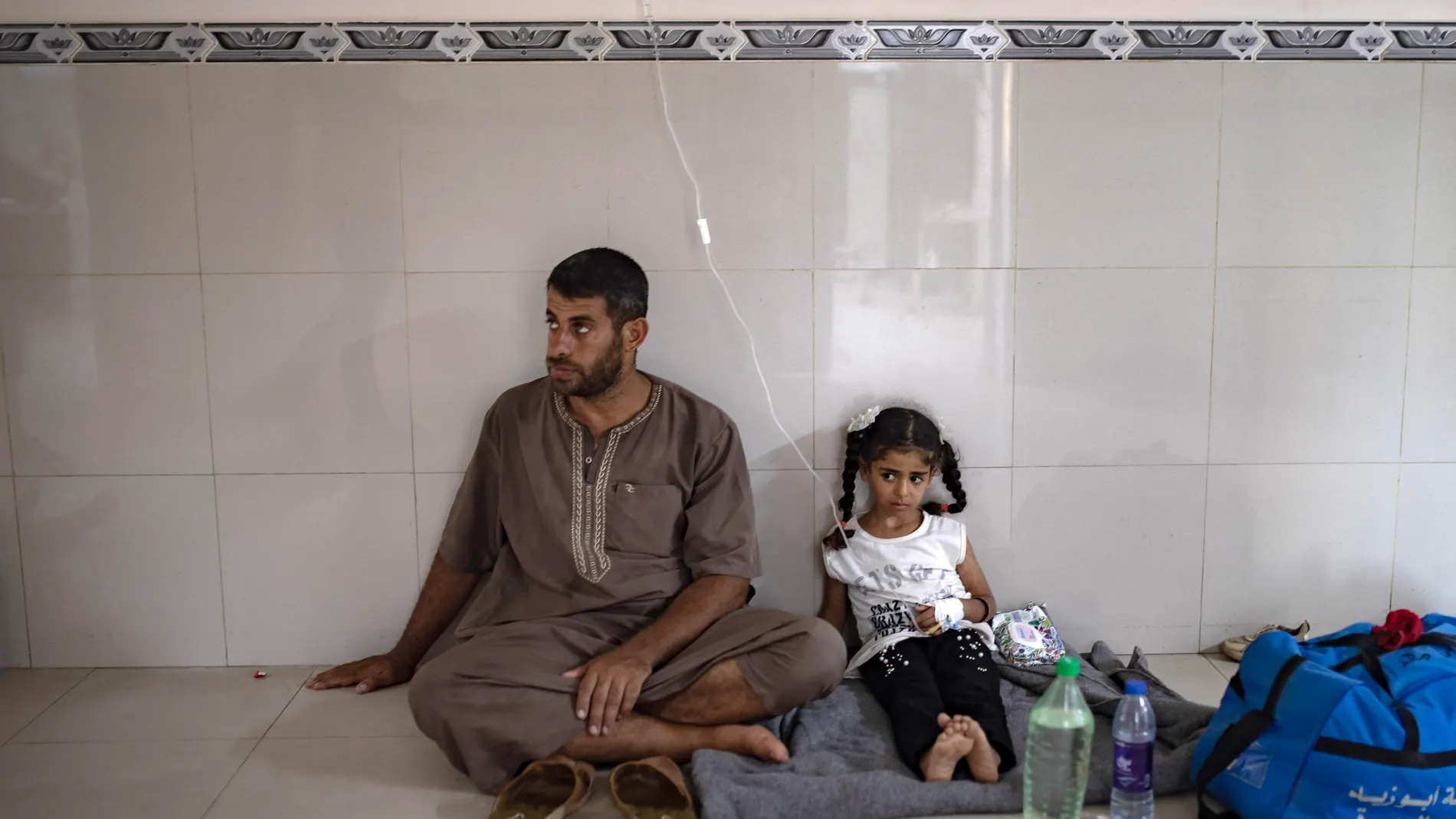 Khan Yunis (-), 08/07/2024.- A Palestinian girl suffering from malnutrition sits on the floor over a blanket at Nasser Hospital in Khan Yunis, southern Gaza Strip, 08 July 2024. According to the UN, famine is 'imminent' in Gaza as half of its population, 1.1 million people, faces 'catastrophic food insecurity' due to the conflict and restrictions on humanitarian access. Children's acute malnutrition rates have rapidly increased, with one in three children under two years of age suffering from...