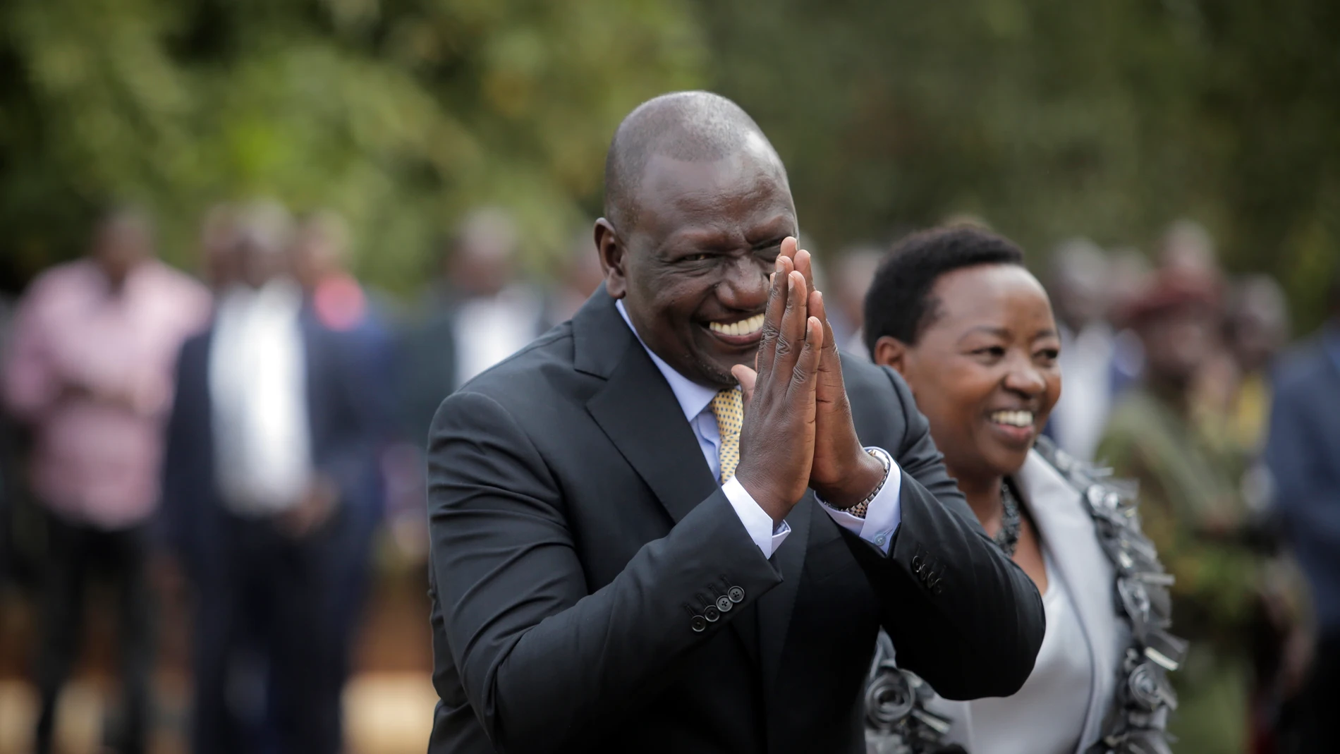 FILE - Kenya's President William Ruto gestures to party officials as he walks with his wife Rachel Ruto as he prepares to address the media at his official residence in Nairobi, Kenya Monday, Sept. 5, 2022. The ballooning debt in East Africa's economic hub of Kenya is expected to grow even more after deadly protests forced the rejection of a finance bill that President William Ruto said was needed to raise revenue. He now warns “it will have huge consequences.” (AP Photo/Brian Inganga, File)