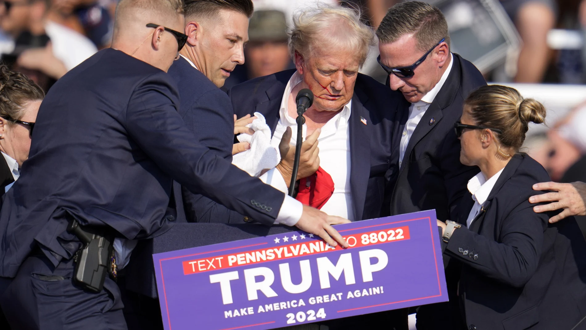 Republican presidential candidate former President Donald Trump is helped off the stage at a campaign event in Butler, Pa., on Saturday, July 13, 2024