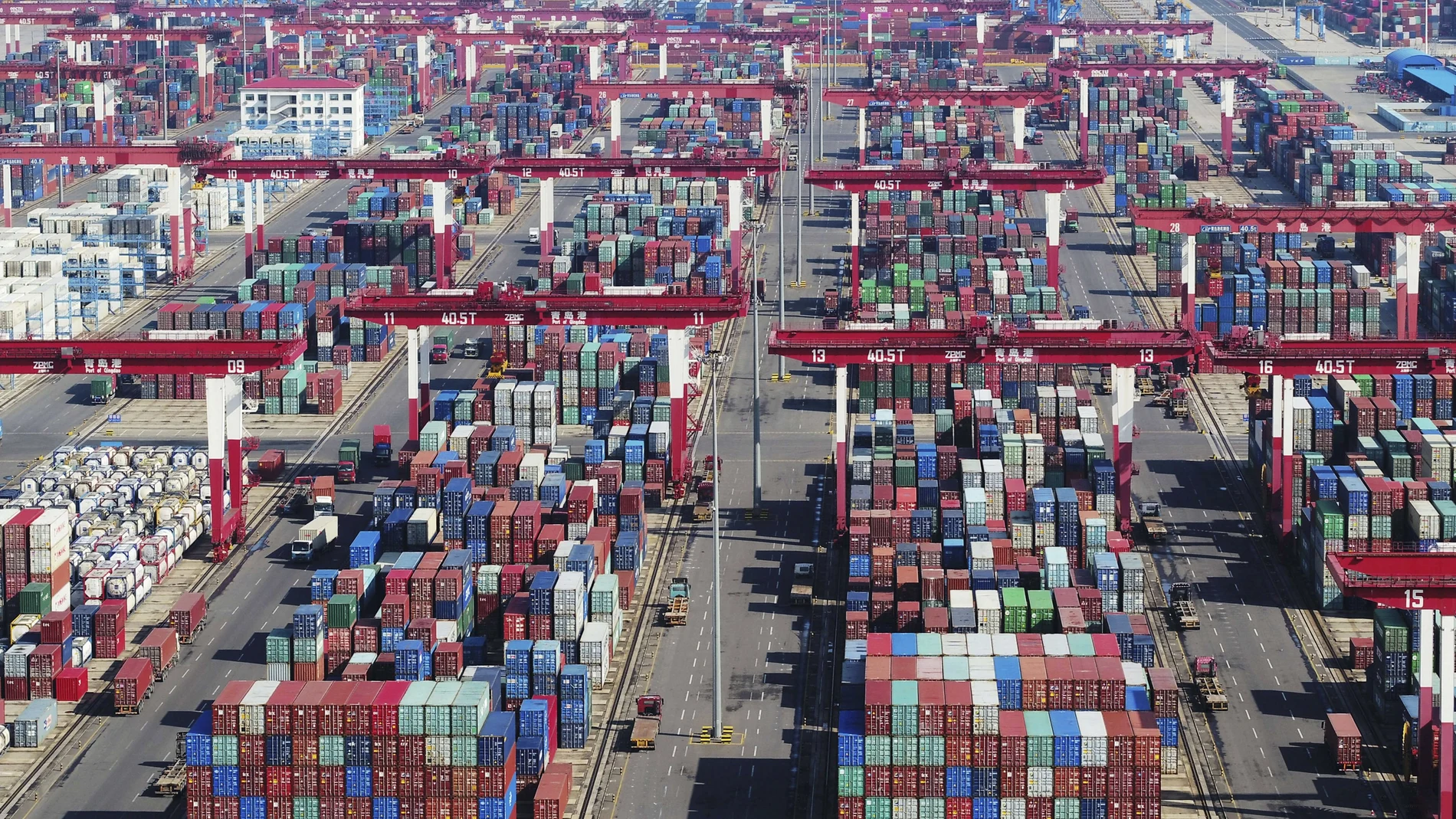 Containers are piled high at a port in Qingdao in eastern China's Shandong province Thursday, Nov. 8, 2018. Growth in Chinese exports to the United States ticked up in October as traders rushed to beat another round of tariff hikes. (Chinatopix via AP)