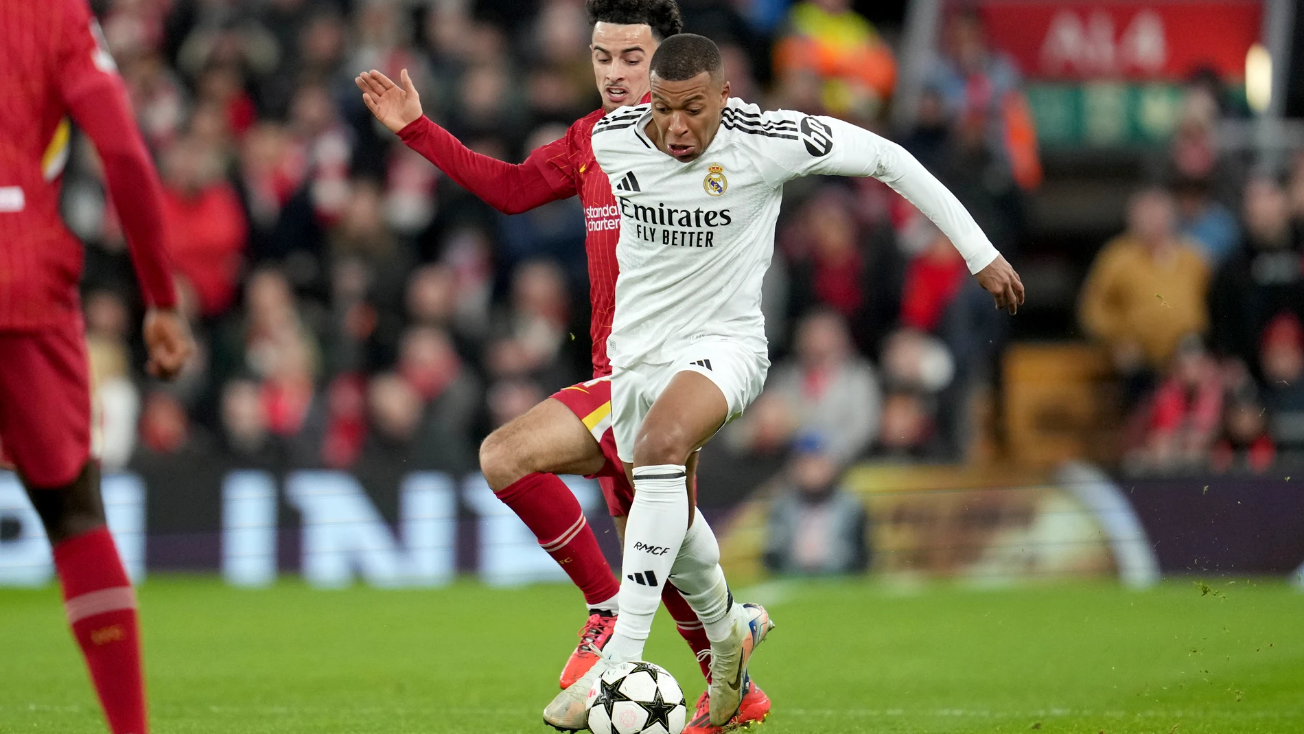 Real Madrid's Kylian Mbappe, right, vies for the ball with Liverpool's Curtis Jones during the Champions League opening phase soccer match between Liverpool and Real Madrid at Anfield Stadium, Liverpool, England, Wednesday, Nov. 27, 2024. (AP Photo/Jon Super)