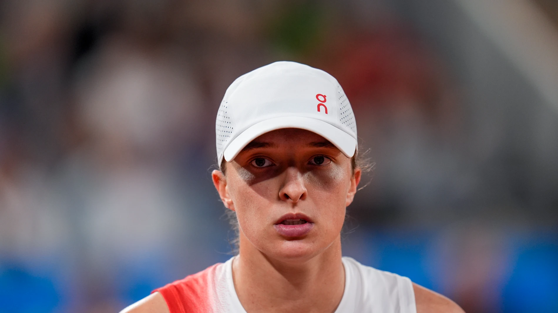 FILE - Iga Swiatek of Poland looks on during her match against Irina-Camelia Begu of Romania during a women's singles tennis competition, at the 2024 Summer Olympics, Saturday, July 27, 2024, in Paris, France. (AP Photo/Manu Fernandez, File)