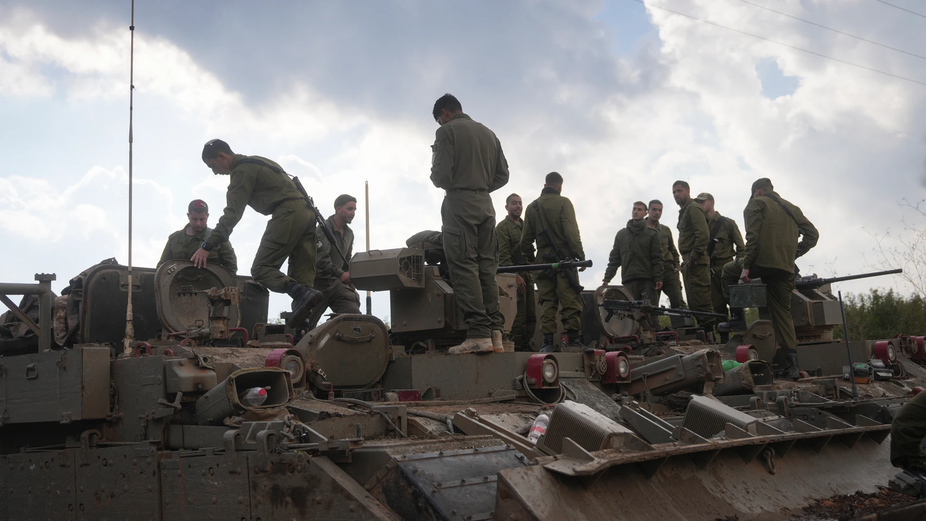 Israeli soldiers stand atop army armoured vehicles outside the agricultural settlement of Avivim, next to the Lebanese border in upper Galilee, Israel, Thursday Nov 28, 2024. (AP Photo/Ohad Zwigenberg)